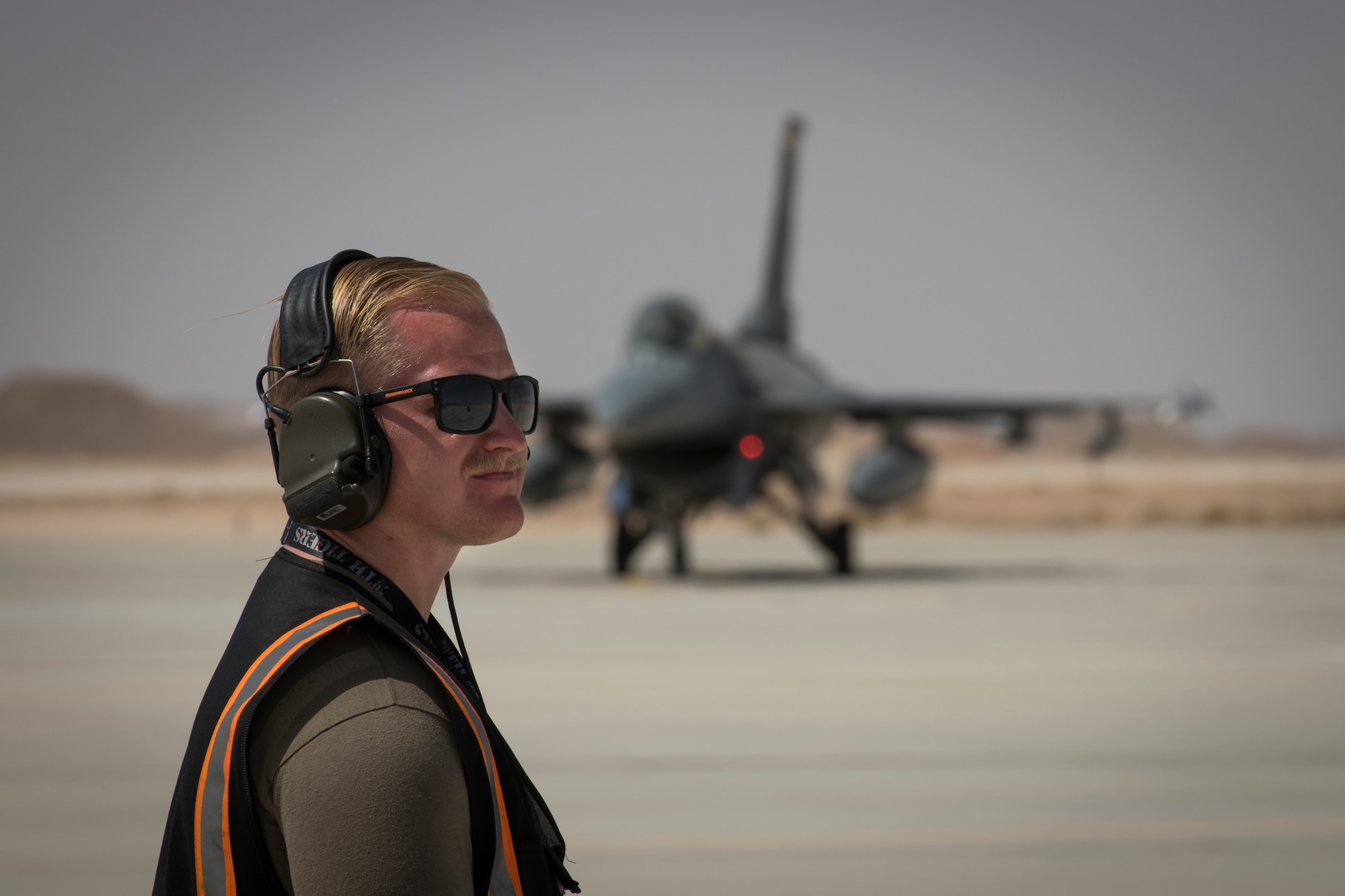 U.S Air Force Staff Sgt. David Williams, a crew chief with the 380th Expeditionary Aircraft Maintenance Squadron prepares to marshal a U.S. Air Force F-16 “Viper” Fighting Falcon assigned to the 79th Expeditionary Fighter Squadron at an undisclosed location in the U.S. Central Command area of responsibility, Feb. 14, 2020.