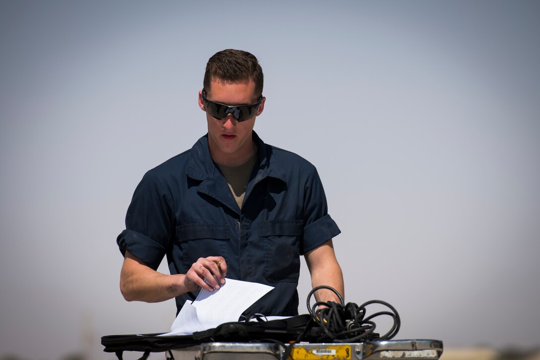 U.S Air Force Airman 1st Class Lucas Haas, a crew chief with the 380th Expeditionary Aircraft Maintenance Squadron fills out maintenance logs at an undisclosed location in the U.S. Central Command area of responsibility, Feb. 14, 2020.