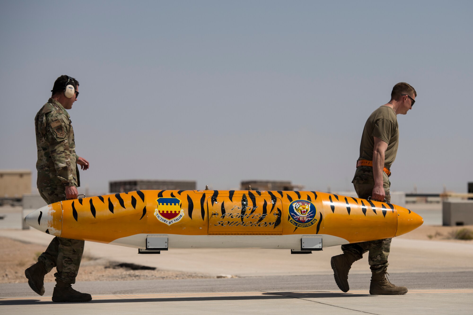 Munitions systems specialists with the 380th Expeditionary Aircraft Maintenance Squadron transport a storage pod of a U.S. Air Force F-16 “Viper” Fighting Falcon at an undisclosed location in the U.S. Central Command area of responsibility, Feb. 14, 2020.