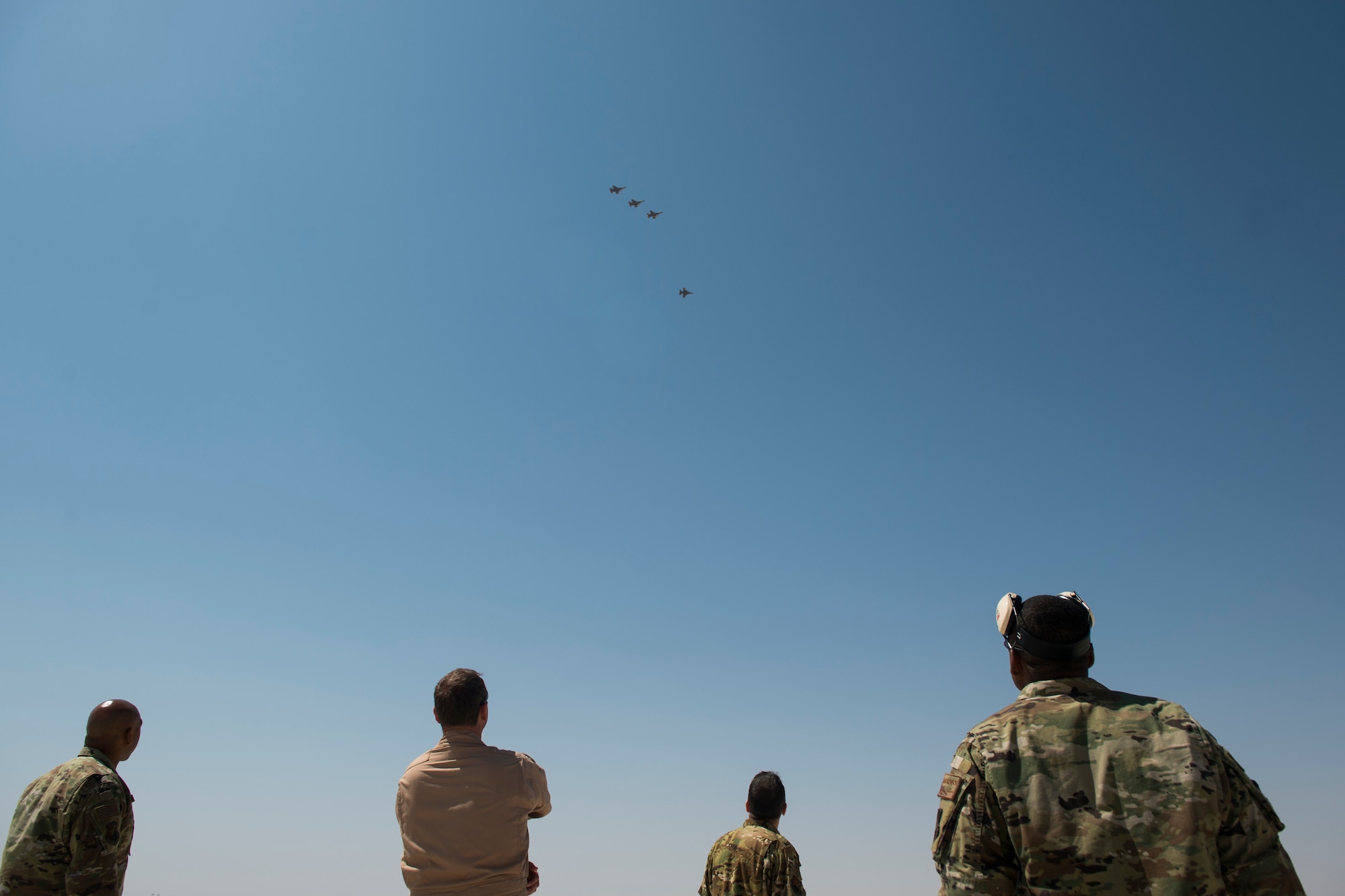 U.S. Air Force senior leadership with U.S. Air Forces Central Command Air Warfare Center look on as four U.S. Air Force F-16 “Viper” Fighting Falcons assigned to the 79th Expeditionary Fighter Squadron fly above an undisclosed location in the U.S. Central Command area of responsibility, Feb. 14, 2020.