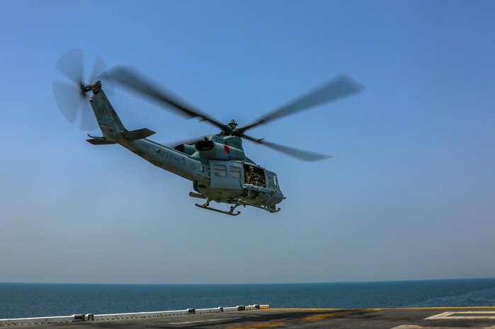 A U.S. Marine Corps UH-1Y Venom assigned to Marine Medium Tiltrotor Squadron (VMM) 365 (reinforced), 26th Marine Expeditionary Unit (MEU), departs the amphibious assault ship USS Bataan (LHD 5) during a transit through the Strait of Hormuz April 3, 2020. Bataan, with embarked 26th MEU, is deployed to the U.S. 5th Fleet area of operations in support of naval operations to ensure maritime stability and security in the Central Region, connecting the Mediterranean and Pacific through the Western Indian Ocean and three strategic choke points. (U.S. Marine Corps photo by Cpl. Gary Jayne III)