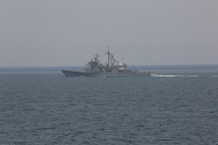 The guided-missile cruiser USS Vella Gulf (CG 72) transits the Strait of Hormuz alongside the amphibious assault ship USS Bataan (LHD 5) April 3, 2020. Bataan, with embarked 26th Marine Expeditionary Unit, is deployed to the U.S. 5th Fleet area of operations in support of naval operations to ensure maritime stability and security in the Central Region, connecting the Mediterranean and Pacific through the Western Indian Ocean and three strategic choke points. (U.S. Marine Corps photo by Cpl. Gary Jayne III)