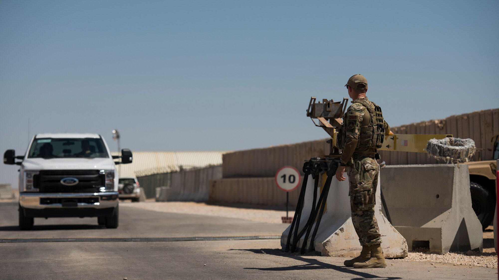 U.S. Air Force Airman Brec Voges, a security forces member with the 379th Expeditionary Security Forces Squadron, monitors an entry control point at an undisclosed location in the U.S. Central Command area of responsibility, Feb. 18, 2020.