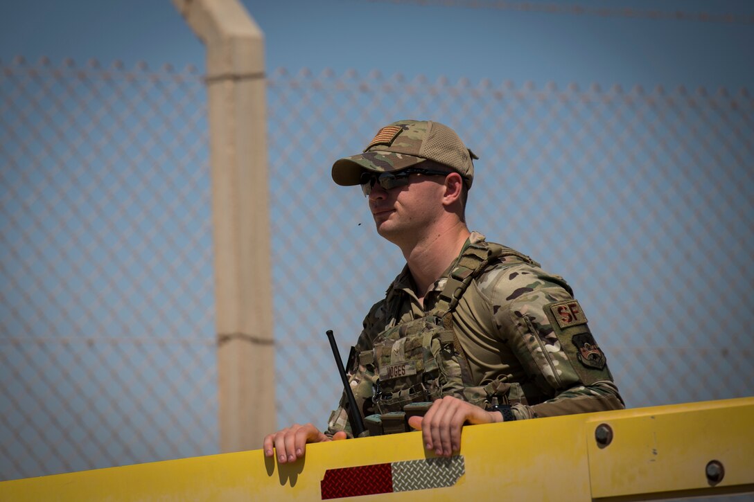 U.S. Air Force Airman Brec Voges, a security forces member with the 379th Expeditionary Security Forces Squadron, opens an entry control point at an undisclosed location in the U.S. Central Command area of responsibility, Feb. 18, 2020.