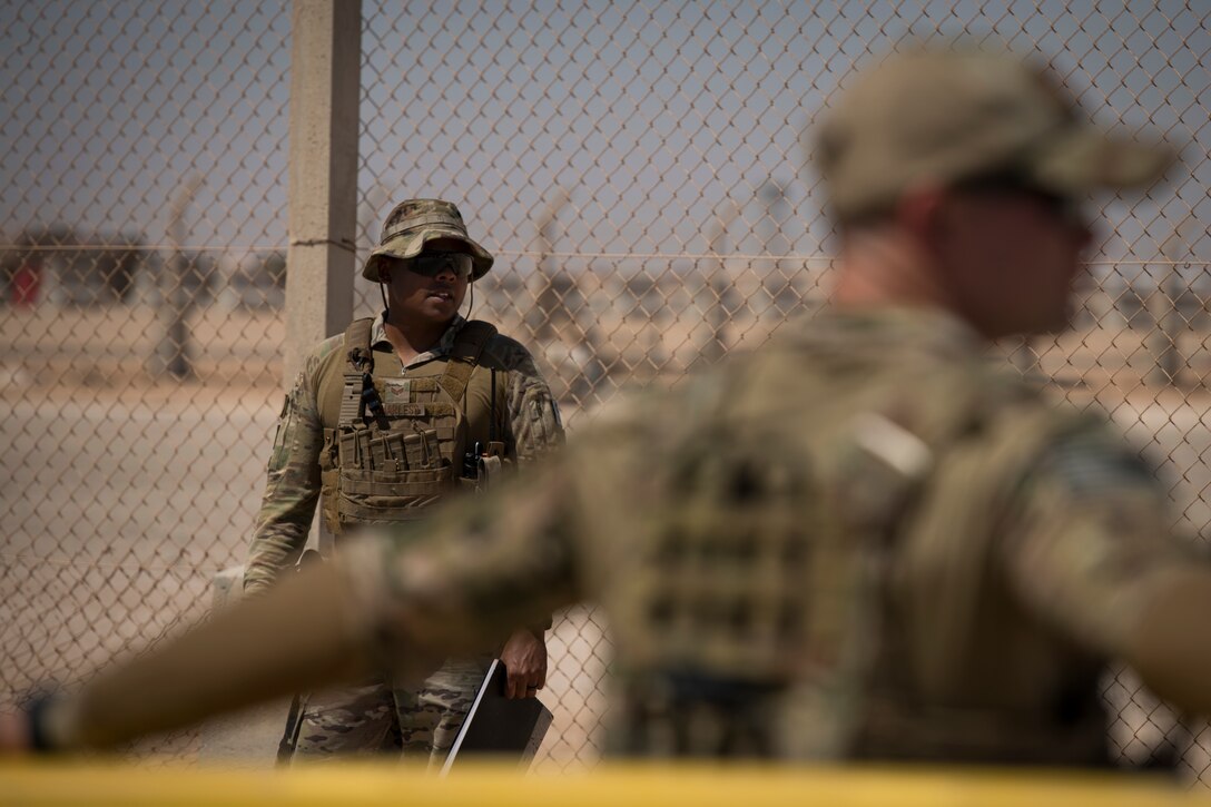 U.S. Air Force Senior Airman Thaddeus Quarles, left, and U.S. Air Force Airman Brec Voges, security forces members with the 379th Expeditionary Security Forces Squadron, monitor an entry control point at an undisclosed location in the U.S. Central Command area of responsibility, Feb. 18, 2020.