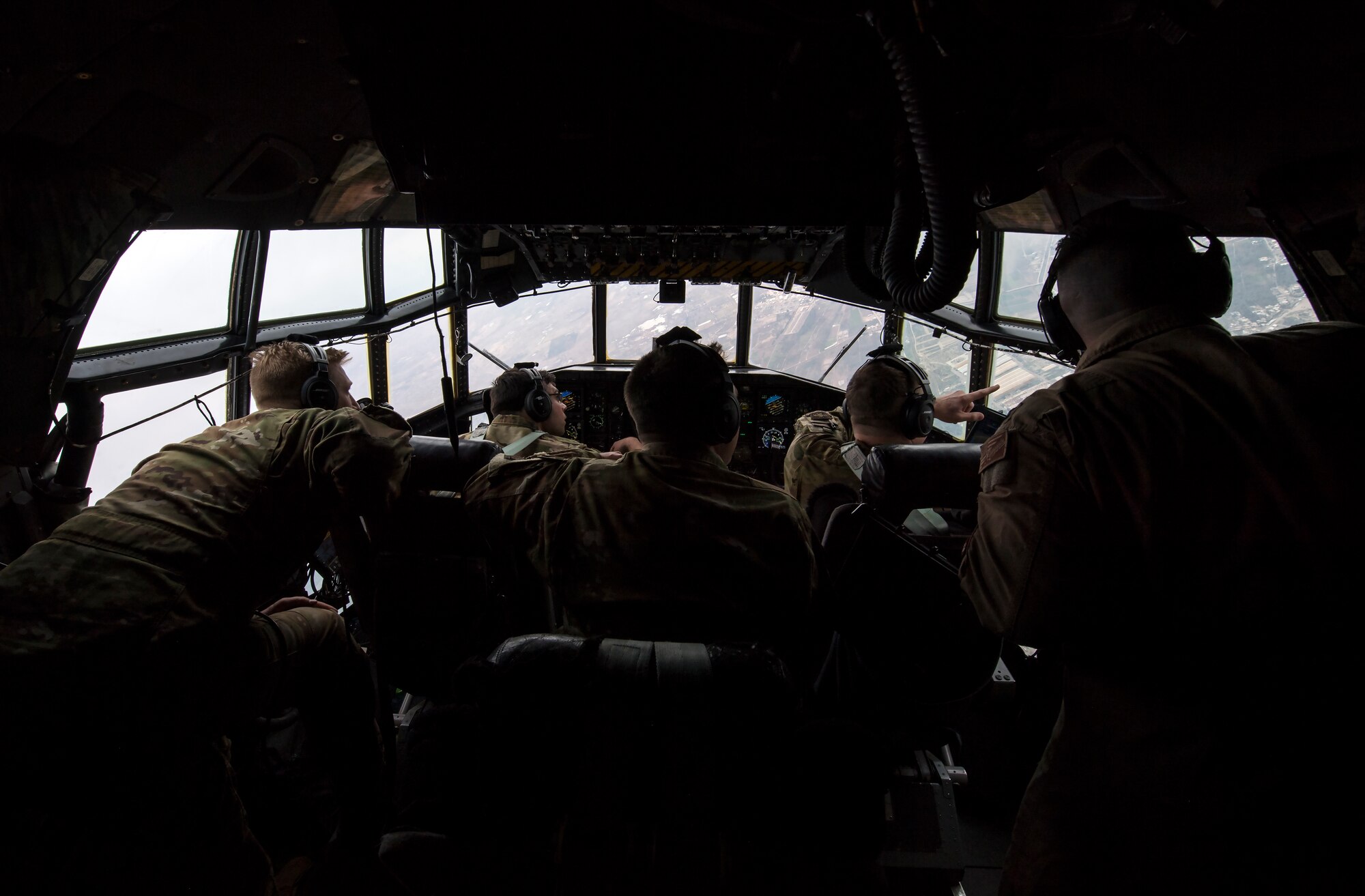 U.S. Air Force C-130H Hercules pilots, flight engineer and navigator,assigned to the 779th Expeditionary Airlift Squadron, look for an airfield in Iraq while flying, Feb. 20, 2020.