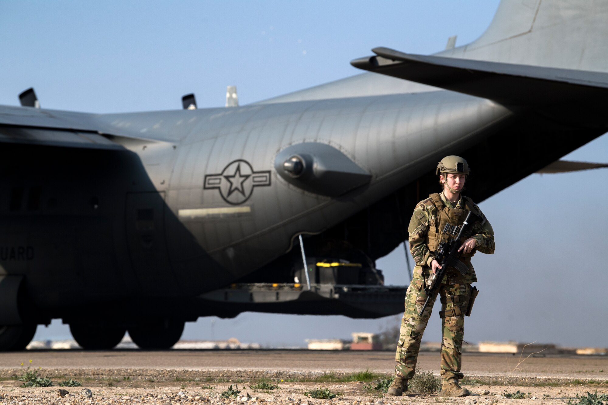 A U.S. Air Force Security Forces Raven assigned to the 779th Expeditionary Airlift Squadron, guards a C-130H Hercules during a cargo pickup in Iraq, Feb. 20, 2020.