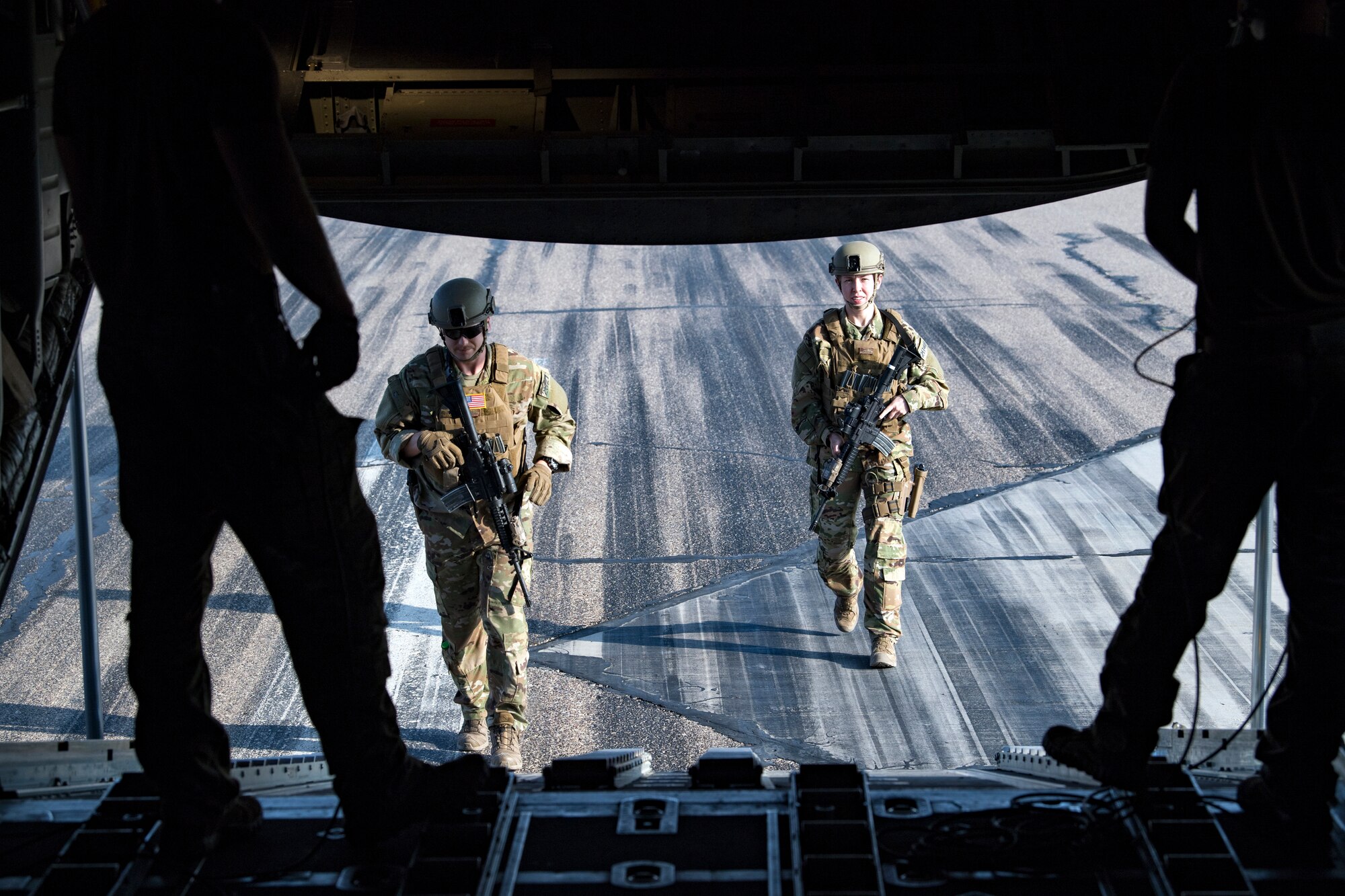 U.S. Air Force Security Forces Ravens assigned to the 779th Expeditionary Airlift Squadron, walk onto a C-130H Hercules Iraq, Feb. 20, 2020.