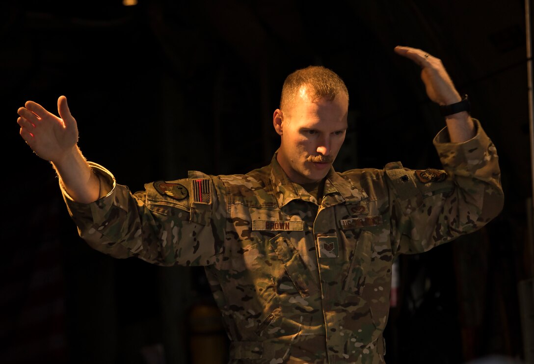 A U.S. Air Force loadmaster assigned to the 779th Expeditionary Airlift Squadron, guides cargo onto a C-130H Hercules at Ali Al Salem Air Base, Kuwait, Feb. 20, 2020.