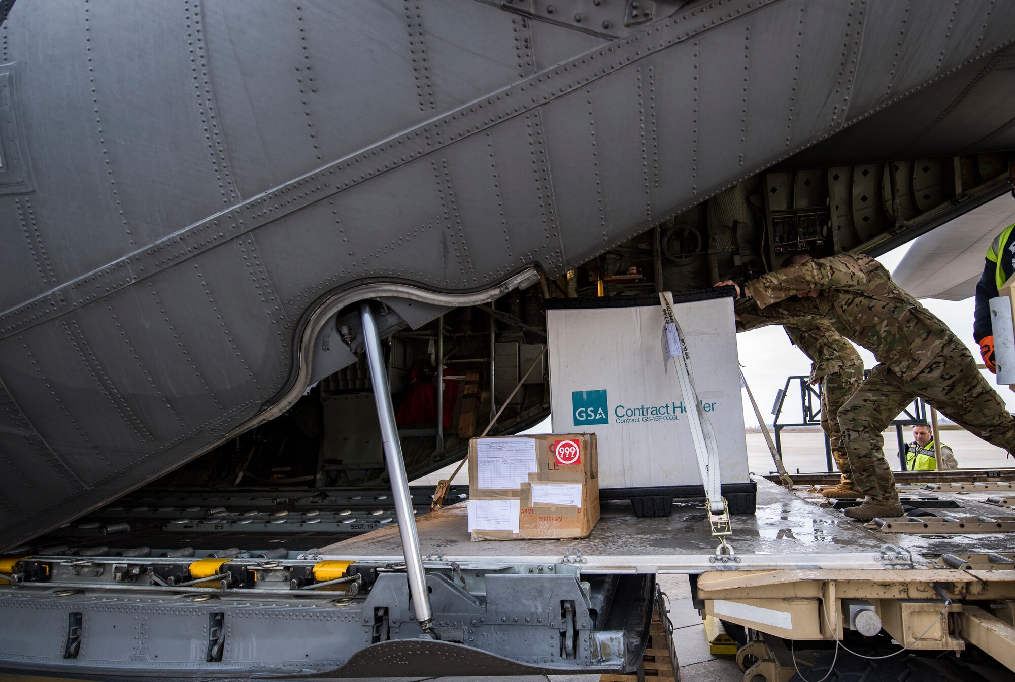 U.S. Air Force loadmasters assigned to the 779th Expeditionary Airlift Squadron, push cargo onto a C-130H Hercules at Ali Al Salem Air Base, Kuwait, Feb. 20, 2020.