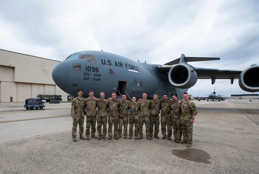 Photo of a group of Airmen in front of an aircraft.