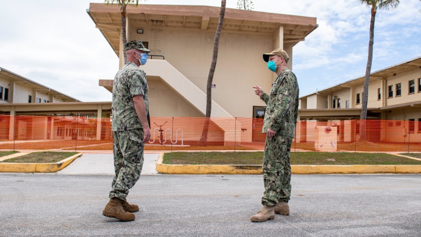 Vice Admiral Bill Merz, commander, U.S. 7th Fleet, meets with the Naval Base Guam Commanding Officer Capt. Jeffrey Grimes and Rear Adm. John Menoni, commander, Joint Region Marianas, outside of a military barracks housing Sailors from USS Theodore Roosevelt (CVN 71), April 5. Merz arrived in Guam to assess and support the ongoing COVID-19 recovery efforts for the crew of Theodore Roosevelt.