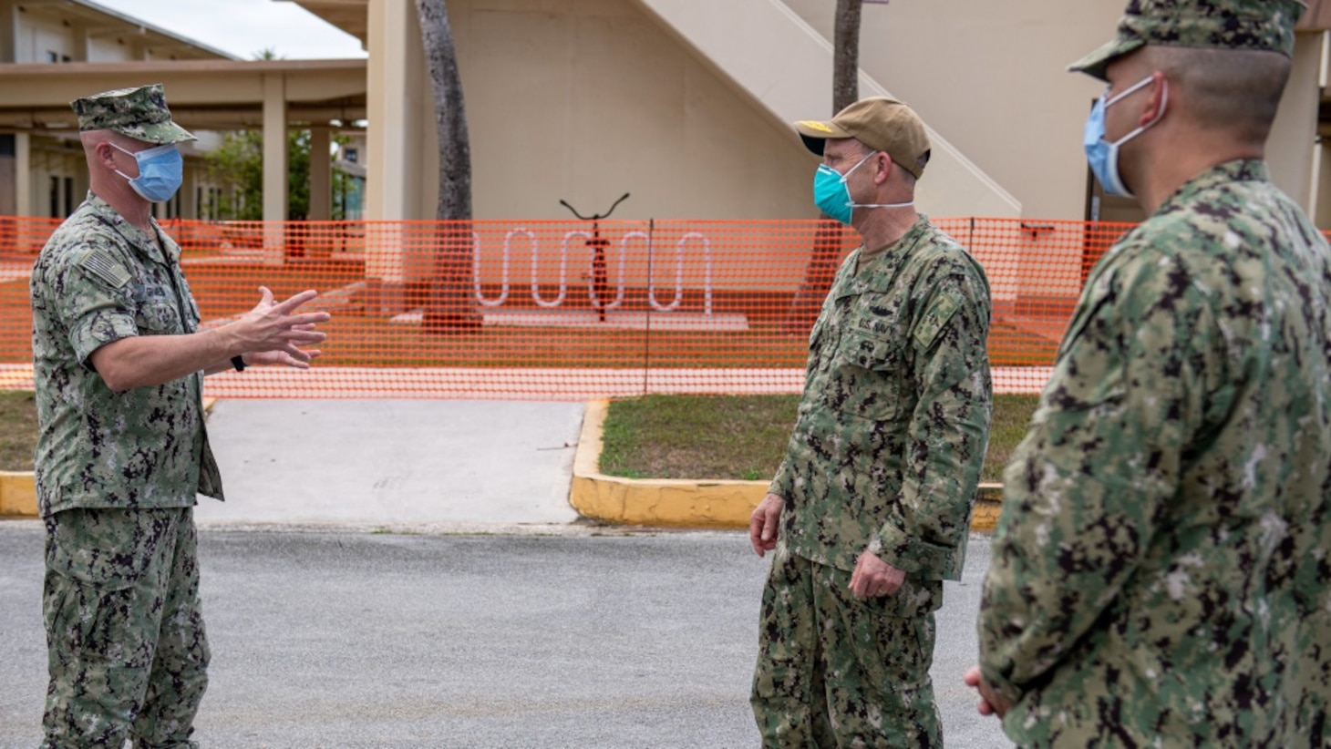 Vice Admiral Bill Merz, commander, U.S. 7th Fleet, meets with the Naval Base Guam Commanding Officer Capt. Jeffrey Grimes and Rear Adm. John Menoni, commander, Joint Region Marianas, outside of a military barracks housing Sailors from USS Theodore Roosevelt (CVN 71), April 5. Merz arrived in Guam to assess and support the ongoing COVID-19 recovery efforts for the crew of Theodore Roosevelt.