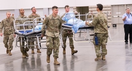 Texas Army National Guard troops set up a field hospital in response to COVID-19 April 1, 2020, at the Kay Bailey Hutchison Convention Center in Dallas. Service members across Texas worked to set up geographically separated units to support local communities.