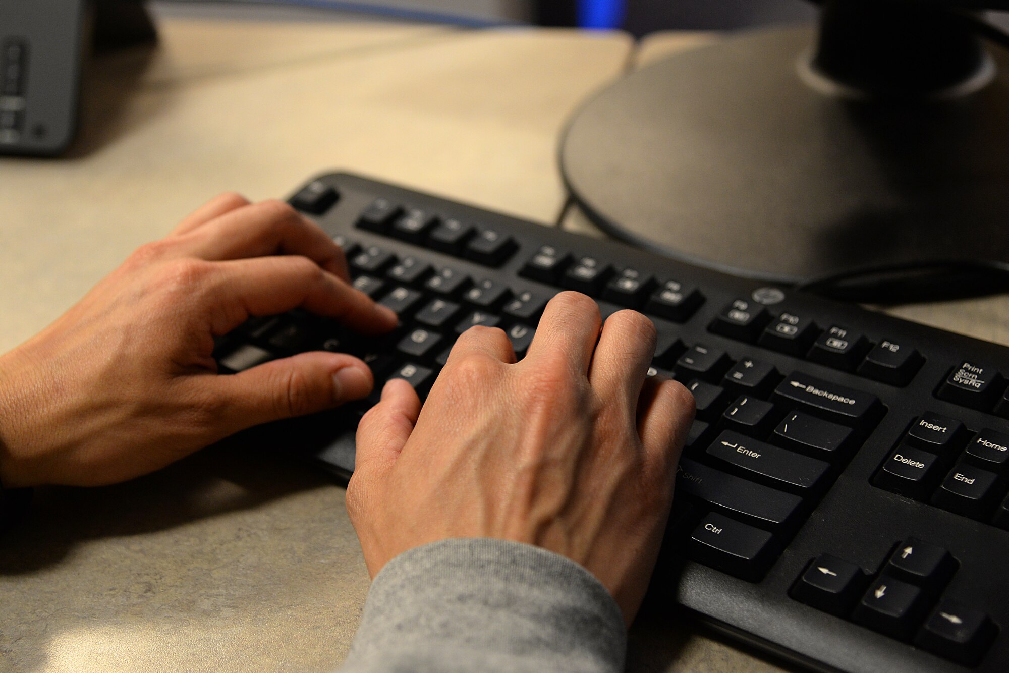 An image of a 177th Fighter Wing unit member utilizing a computer to accomplish training during a virtual Unit Training Assembly