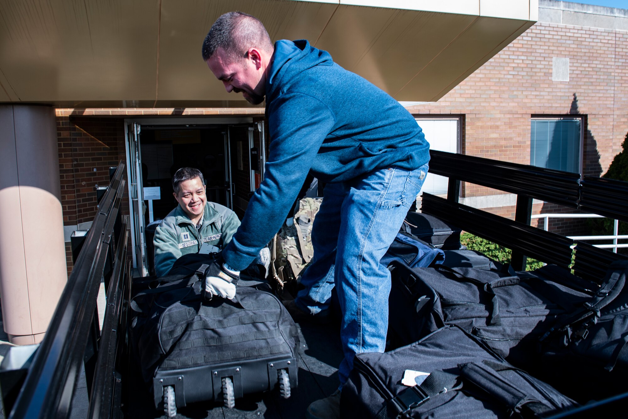 Capt. Tyro De Ocera, 911th Aeromedical Staging Squadron nurse, loads his luggage onto the back of a truck during the mobilization process at the Pittsburgh International Airport Air Reserve Station, Pennsylvania, April 5, 2020.