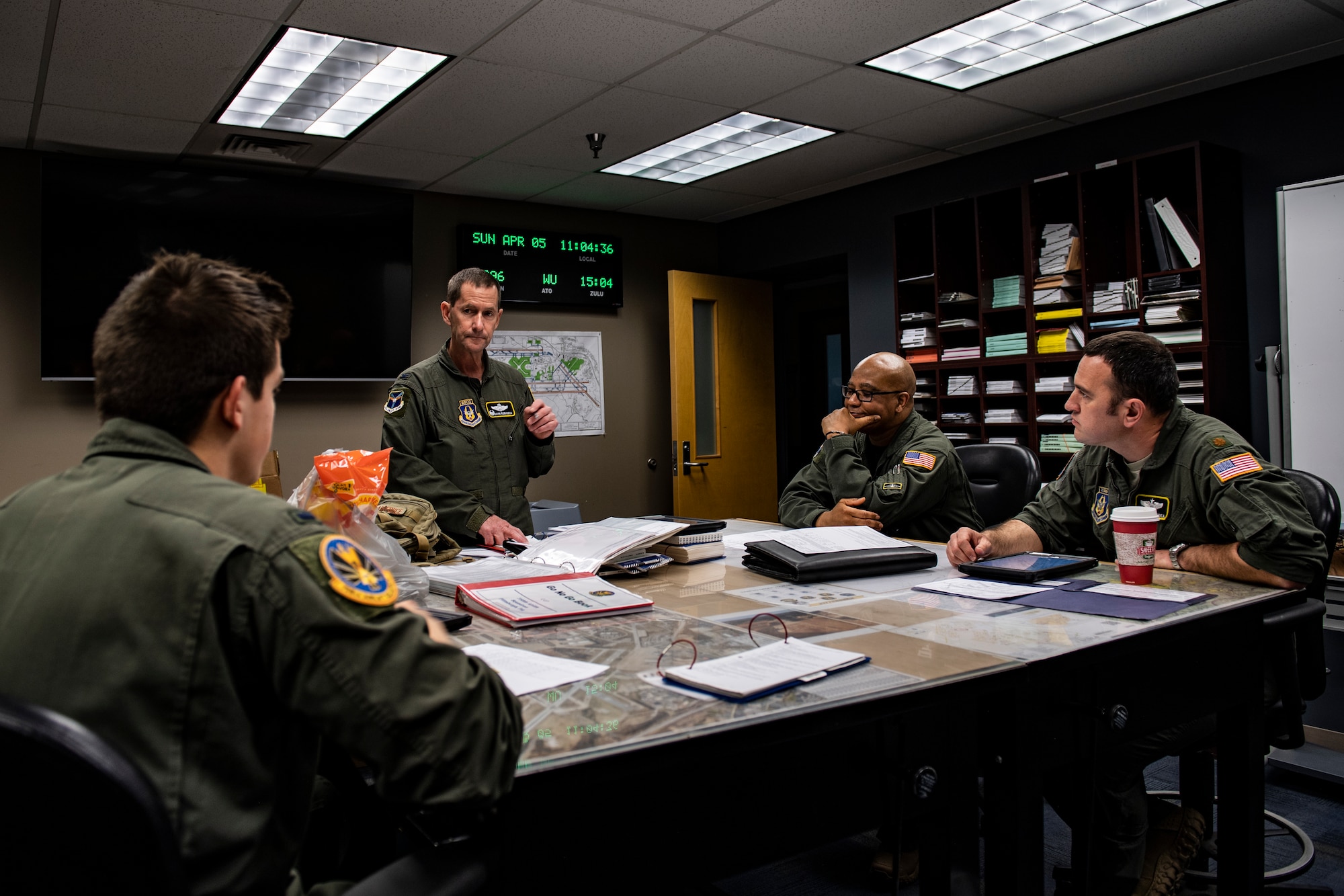 Col. John F. Robinson, 911th Airlift Wing commander, talks with other aircrew members at the Pittsburgh International Airport Air Reserve Station, Pennsylvania before transporting mobilized Airmen to Joint Base Mcguire-Dix-Lakehurst in support of the COVID-19 efforts, April 5, 2020.