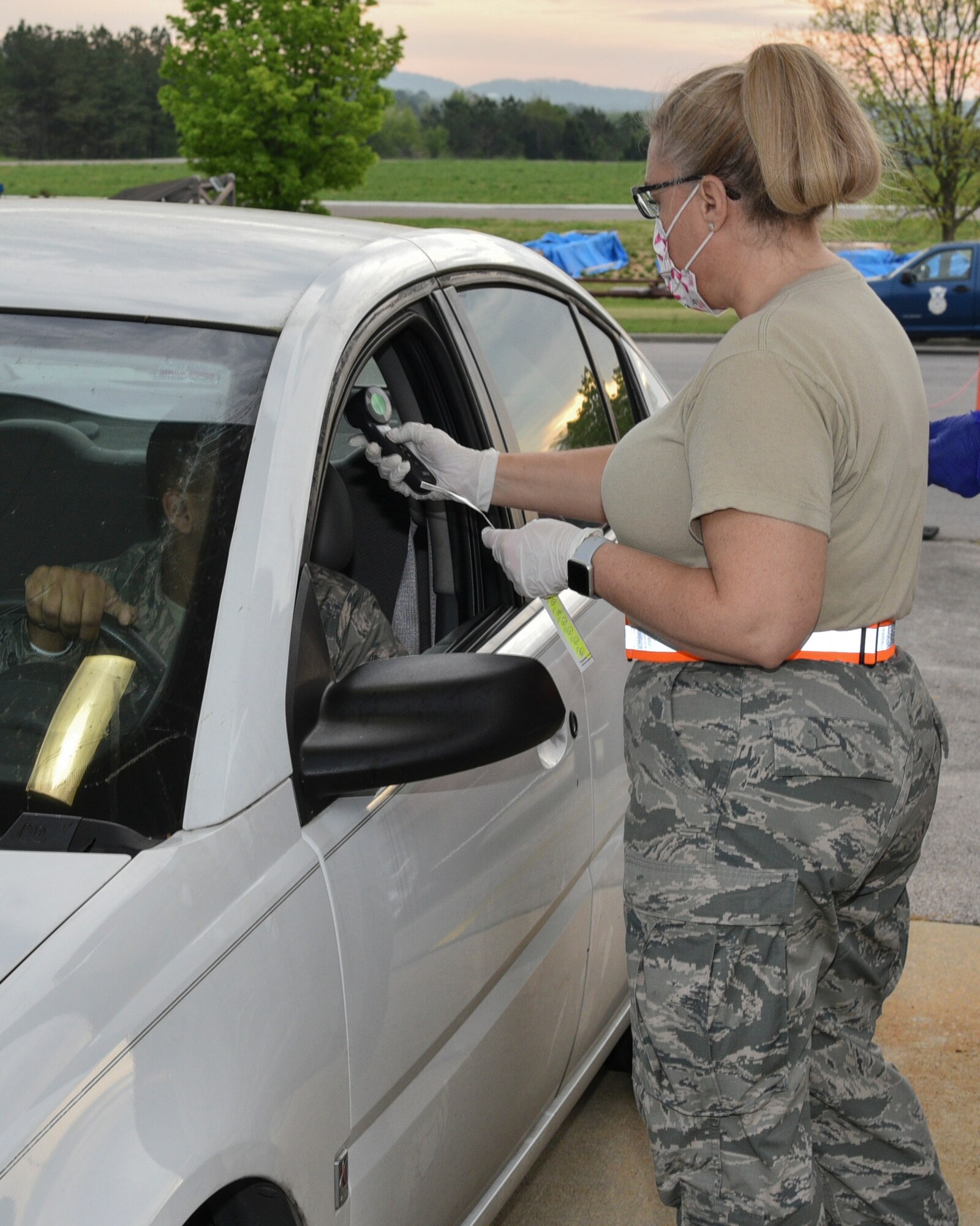 Medical staff of the 117th Air Refueling Wing Medical Group perform manditory screenings of personnel prior to entry to the 117th Air Refueling Wing, Sumpter Smith Joint National Guard Base, Birmingham, Alabama during the COVID 19 outbreak March 27, 2020. (U.S. Air National Guard photo by Ken Johnson)