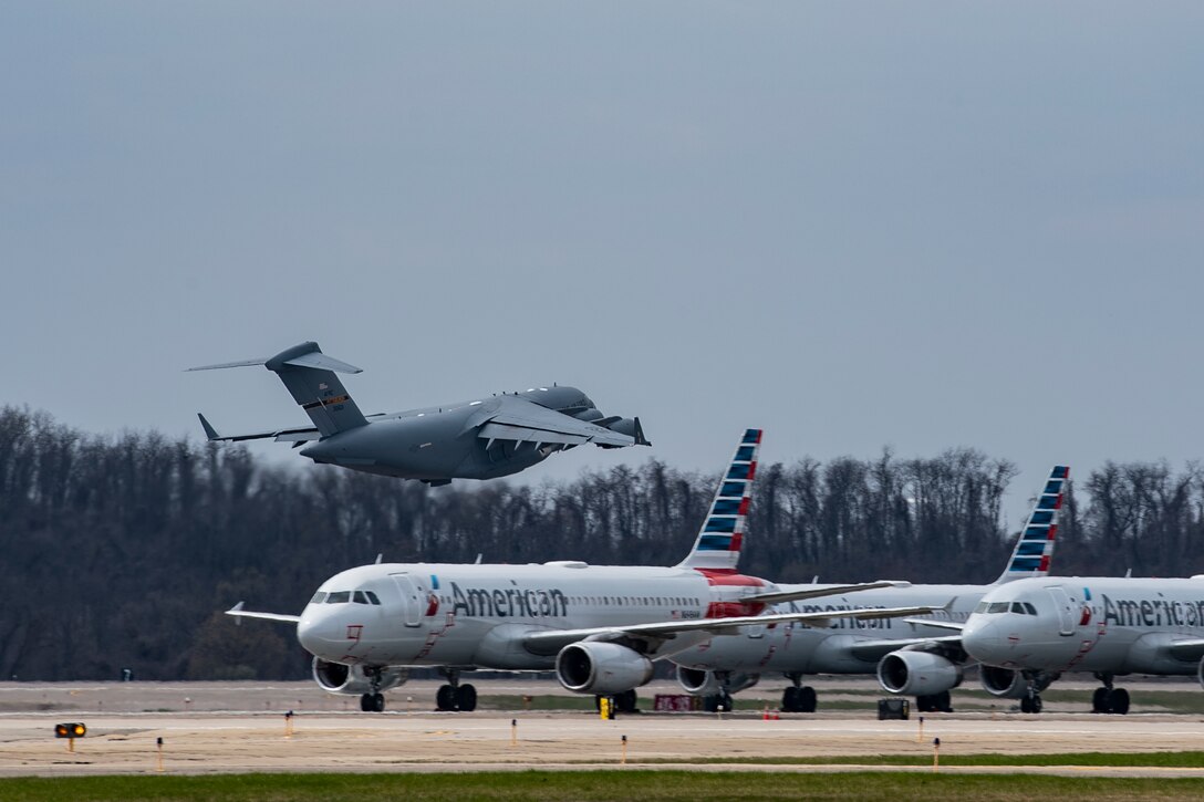 A C-17 Globemaster III assigned to the 911th Airlift Wing transporting mobilized Airmen to Joint Base Mcguire-Dix-Lakehurst, New Jersey in support of the COVID-19 efforts takes-off from the Pittsburgh International Airport Air Reserve Station, Pennsylvania, April 5, 2020.