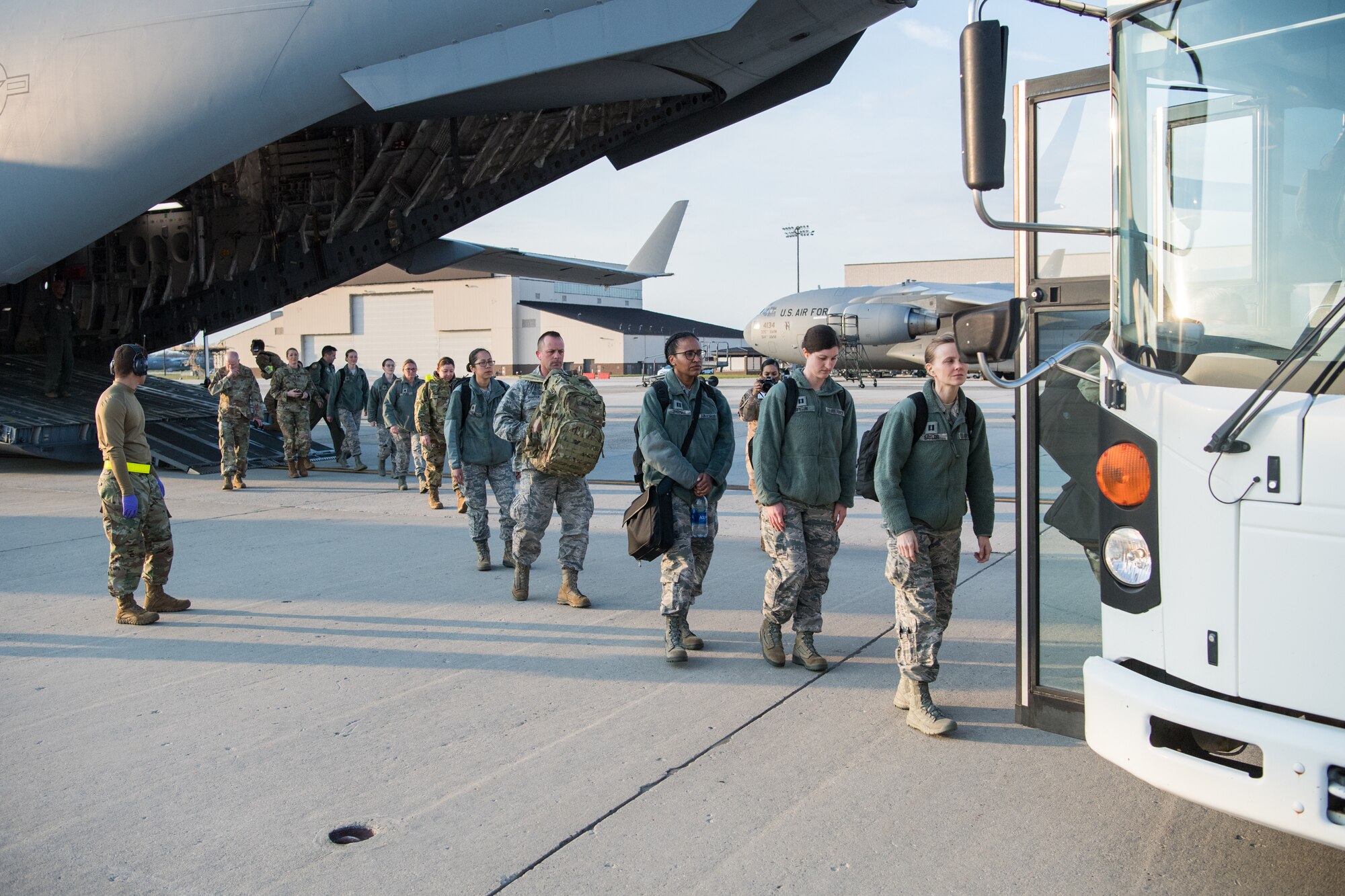 U.S. Reserve Citizen Airmen with medical experience offload from a C-17 Globemaster III with the 911th Airlift Wing at Joint Base McGuire-Dix-Lakehurst, N.J., on their way to support the residents of New York City in the fight against COVID-19, April 5, 2020.