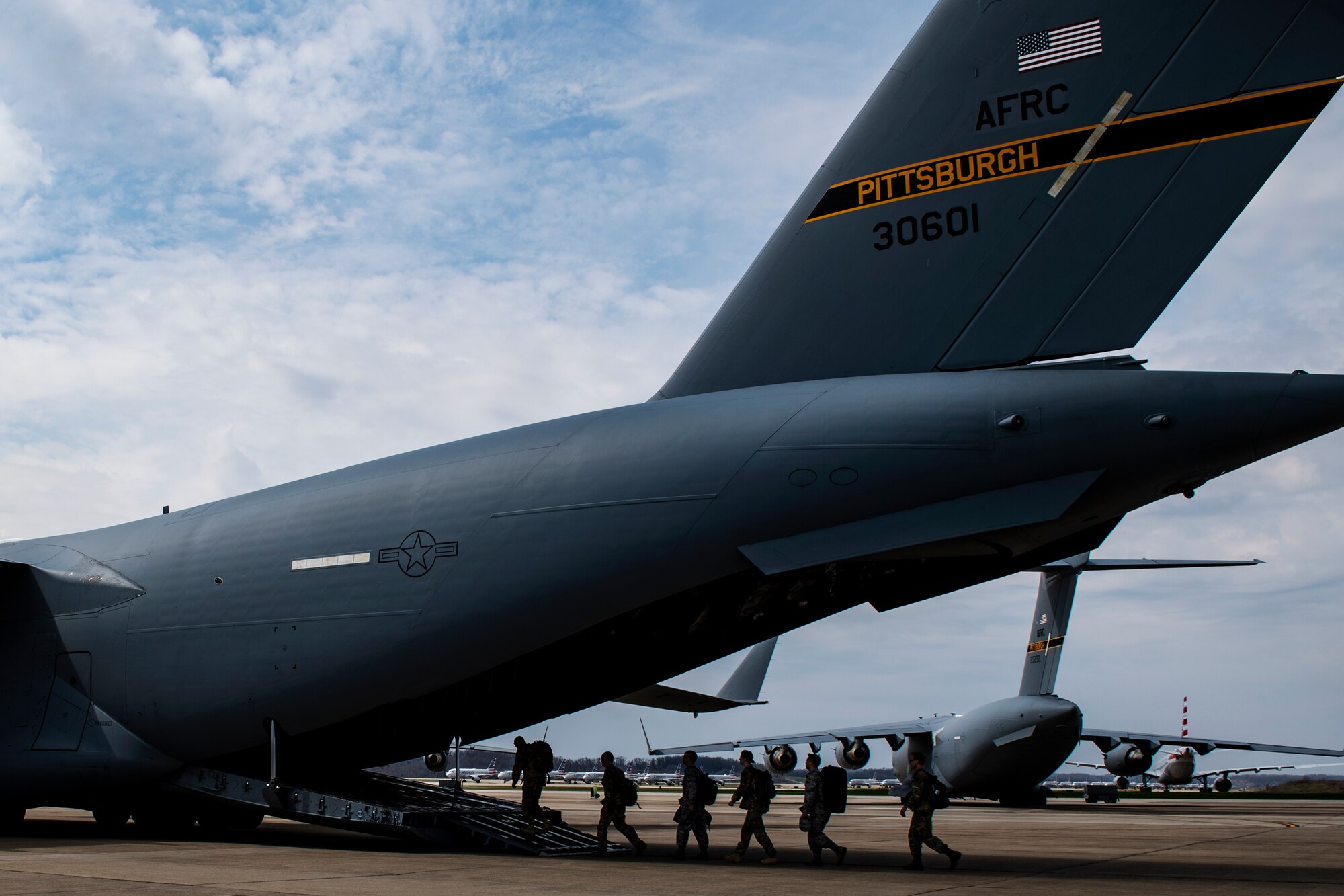 Airmen assigned to the 911th Airlift Wing who were mobilized to support the COVID-19 efforts board onto a C-17 Globemaster III aircraft at the Pittsburgh International Airport Air Reserve Station, Pennsylvania, April 5, 2020.