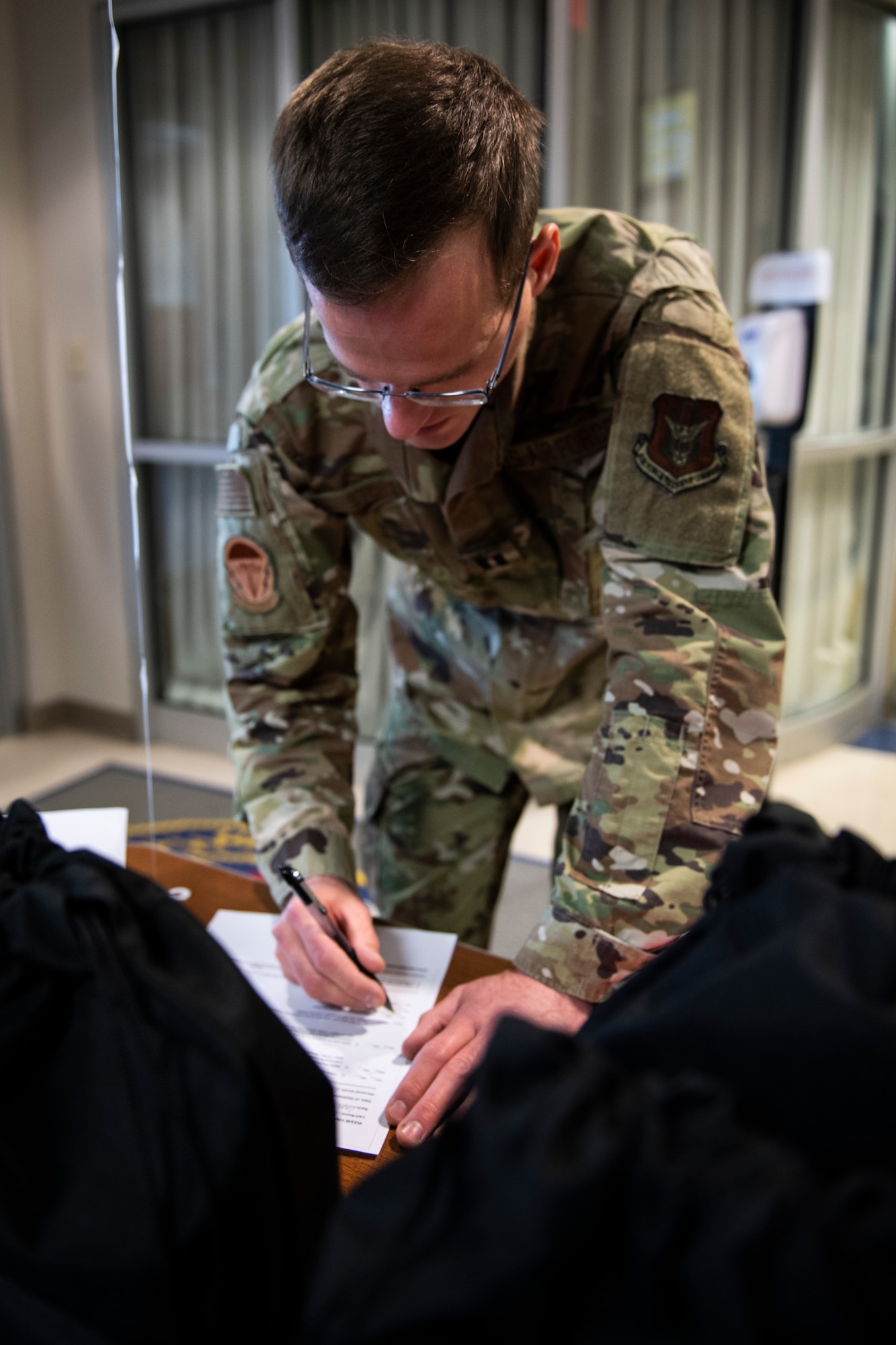 Capt. Brenden Stokes, 911th Aeromedical Staging Squadron nurse, fills out mobilization paperwork at the Pittsburgh International Airport Air Reserve Station, Pennsylvania, April 5, 2020.