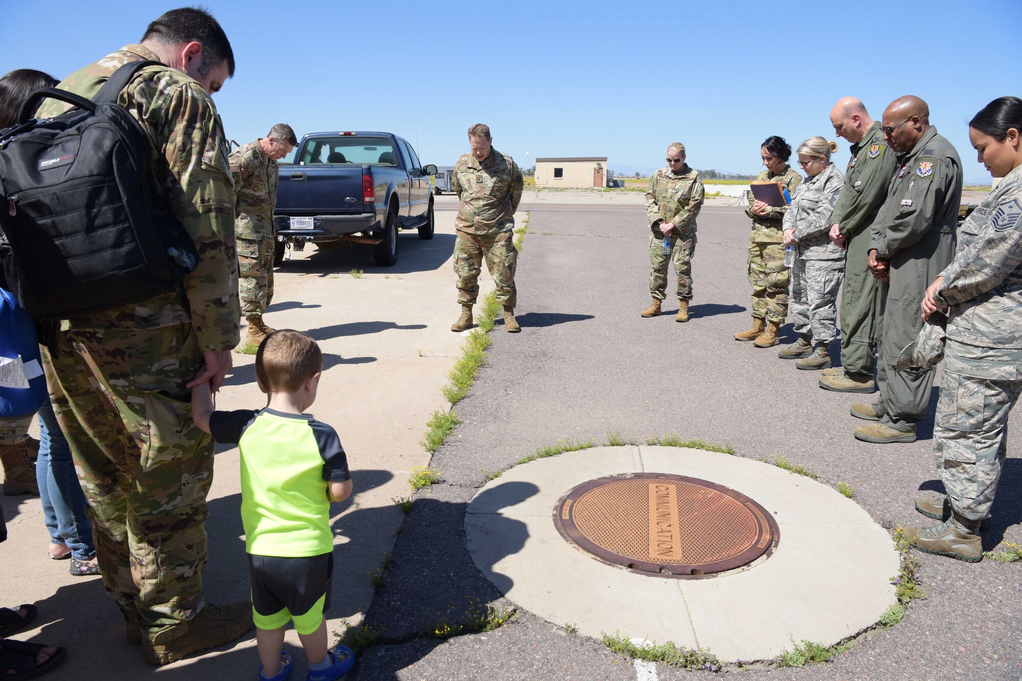 Maj. David Kreis, 944th Fighter Wing chaplain, prays for mobilized Air Force Reserve medics before they board their airlift in support of the COVID-19 pandemic at Luke Air Force Base, Ariz., April 5, 2020. This deployment is part of a larger mobilization package of more than 120 doctors, nurses, and respiratory technicians. Air Force Reserve units across the nation provided over the past 48 hours in support of the COVID-19 response to take care of Americans.