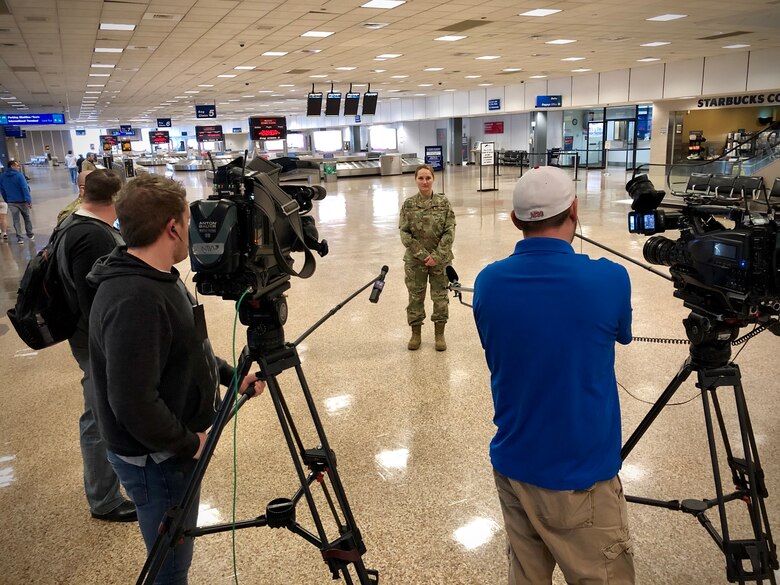 Maj. Katherine Trout, a medic with the 419th Fighter Wing, is interviewed by local news media today at the nearly empty Salt Lake City airport just prior to departing on a flight to the New York City area where she will assist with the city's COVID-19 response
