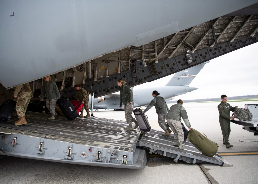 A doctor and several nurses from the 445th Airlift Wing’s Aerospace Medicine and Aeromedical Staging Squadrons, board a C-17 Globemaster III here April 5, 2020 heading to Joint Base McGuire-Dix-Lakehurst. The Airmen were notified April 4, 2020 that they would be mobilized to New York City to help with the COVID-19 pandemic. The Citizen Airmen will join other military personnel providing medical services at the Jacob Javits Center in New York City. This deployment is part of a larger mobilization package of more than 120 doctors, nurses and respiratory technicians Air Force Reserve units across the nation provided over the past 48 hours in support of COVID-19 response to take care of Americans. (U.S. Air Force photo/Mr. Patrick O’Reilly)