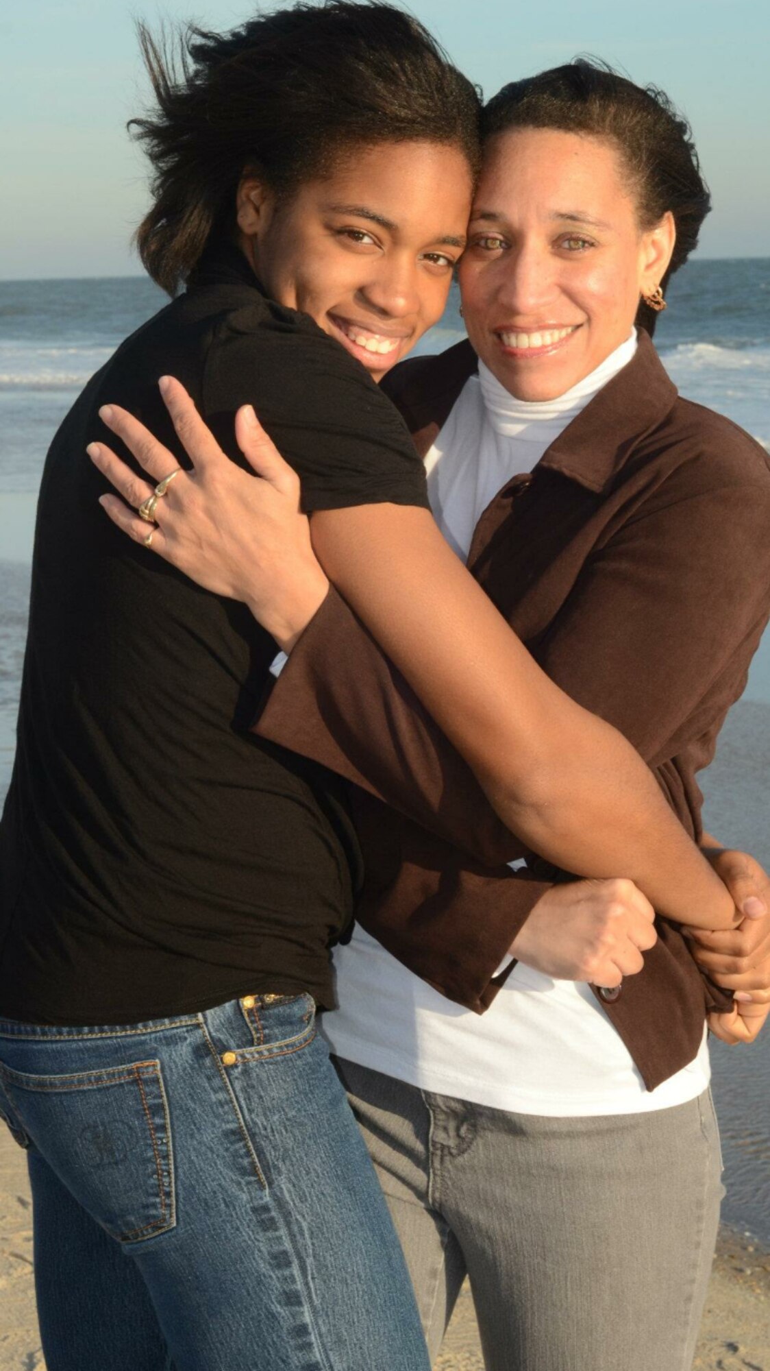 A photo of U.S. Air Force Airman 1st Class Kayla Jerido, 86th Civil Engineer Squadron fire protection apprentice, and her mother, Angei Jerido, hugging and smiling for a photo at Cooper Beach, New York, Dec. 13, 2011.