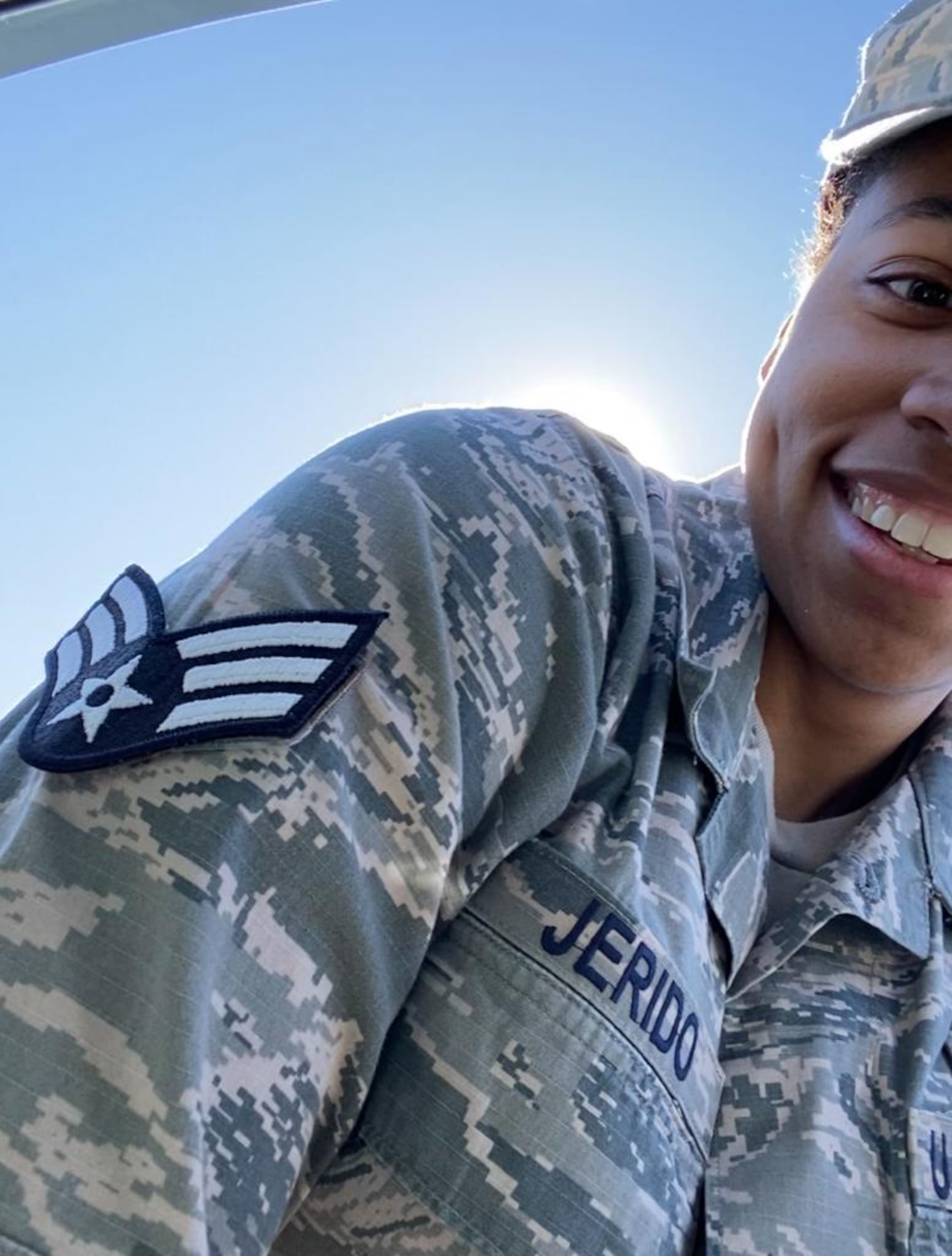 A close-up photo of U.S. Air Force Airman 1st Class Kayla Jerido, 86th Civil Engineer Squadron fire protection apprentice, leans her arm over to show off her below-the-zone promotion stripes at Vogelweh Military Complex, Germany, March 30, 2020.