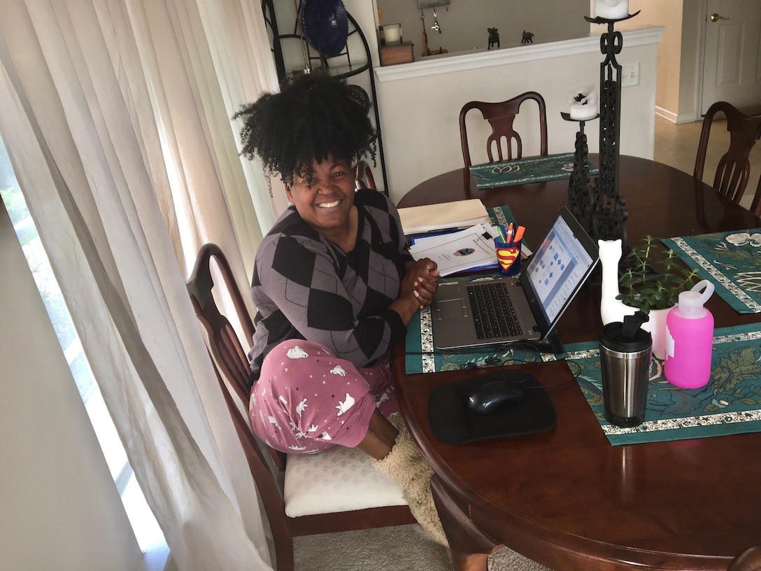 Melody Arnold, a DLA Troop Support Audit Readiness and Compliance business process analyst, poses for a photo at her remote workstation from home April 3, 2020.