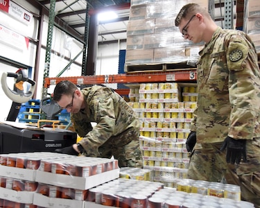 Soldiers from the 1433rd Engineer Company, 507th Engineer Battalion, 177th Military Police Brigade, Michigan Army National Guard, assist the Feeding America West Michigan food bank as part of the Michigan National Guard's coronavirus response, Comstock Park, Michigan, March 31, 2020. The Michigan Guard is helping at five food banks across the state.