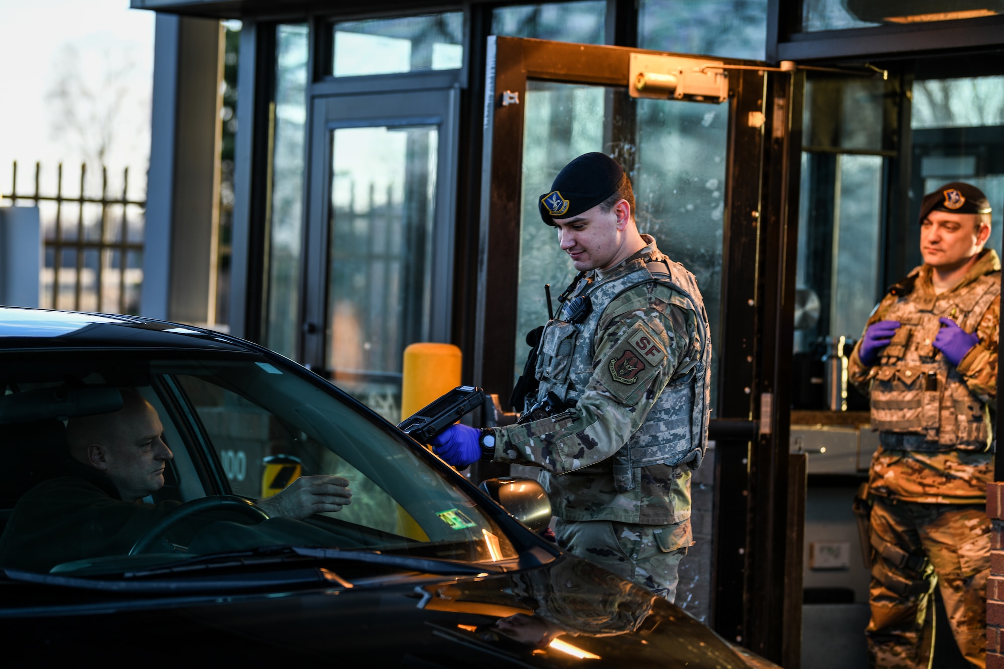 Senior Airman Craig Johnson, a fireteam member assigned to the 910th Security Forces Squadron, checks ID cards, March 26, 2020, at Youngstown Air Reserve Station’s entry gate.