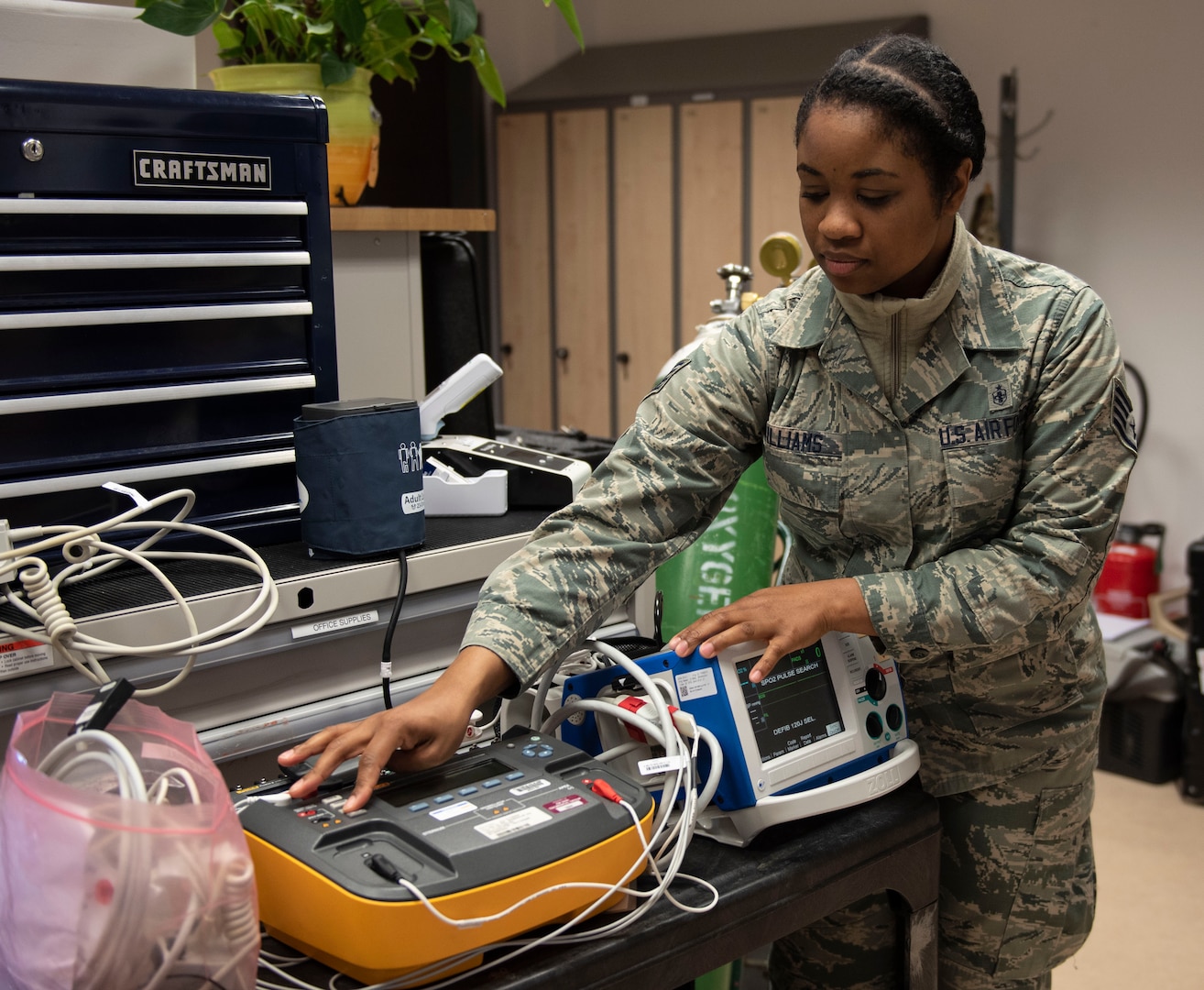 U.S. Air Force Staff Sgt. Neekia Williams, 52nd Medical Group biomedical equipment technician, turns on a defibrillator at Spangdahlem Air Base, Germany, April 1, 2020. Repairing medical equipment is vital to maintaining a healthy base populace. (U.S. Air Force photo by Senior Airman Melody W. Howley)