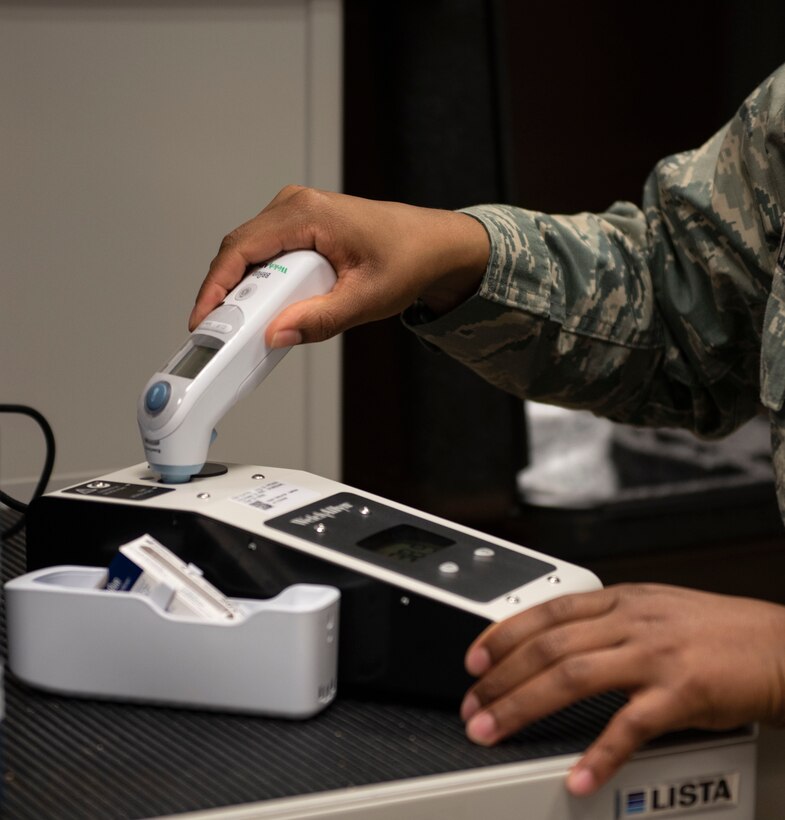 U.S. Air Force Staff Sgt. Neekia Williams, 52nd Medical Group biomedical equipment technician, tests a thermometer at Spangdahlem Air Base, Germany, April 1, 2020. Williams 
ensures thermometers are accurate and ready for patient care. (U.S. Air Force photo by Senior Airman Melody W. Howley)