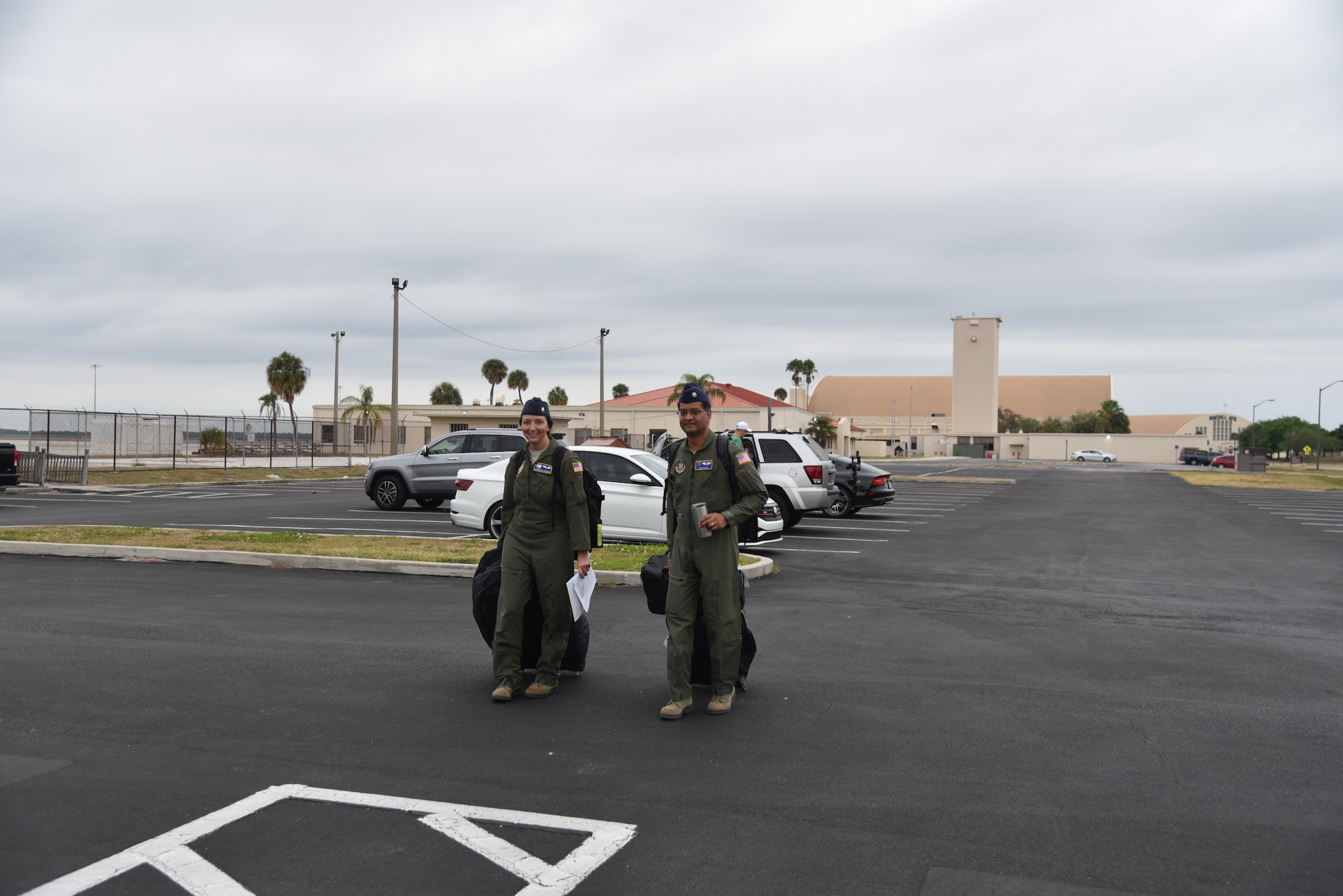 Maj. Jennlee Glaiser (on left) and Lt. Col. Raja Talati,  both flight doctors assigned to the 927th Aerospace Medicine Squadron, MacDill Air Force Base, Fl, head to the MacDill Passenger terminal. With less than  24 hours’ notice, doctors and nurses assigned to the 927th Air Refueling Wing boarded a C-130 at MacDill AFB, Fla., April 5, headed for Joint Base McGuire-Lakehurst, N.J. where they will be a part of more than 100 medical professionals sent from Air Force Reserve Command to work with state and local authorities in the region as they combat COVID-19. (U.S. Air Force photo by Tech. Sgt. Peter Dean)