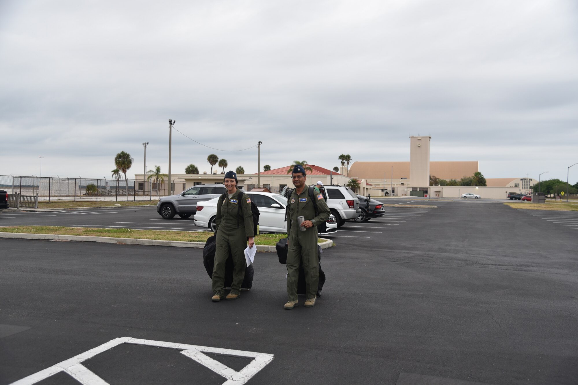 Maj. Jennlee Glaiser (on left) and Lt. Col. Raja Talati,  both flight doctors assigned to the 927th Aerospace Medicine Squadron, MacDill Air Force Base, Fl, head to the MacDill Passenger terminal. With less than  24 hours’ notice, doctors and nurses assigned to the 927th Air Refueling Wing boarded a C-130 at MacDill AFB, Fla., April 5, headed for Joint Base McGuire-Lakehurst, N.J. where they will be a part of more than 100 medical professionals sent from Air Force Reserve Command to work with state and local authorities in the region as they combat COVID-19. (U.S. Air Force photo by Tech. Sgt. Peter Dean)