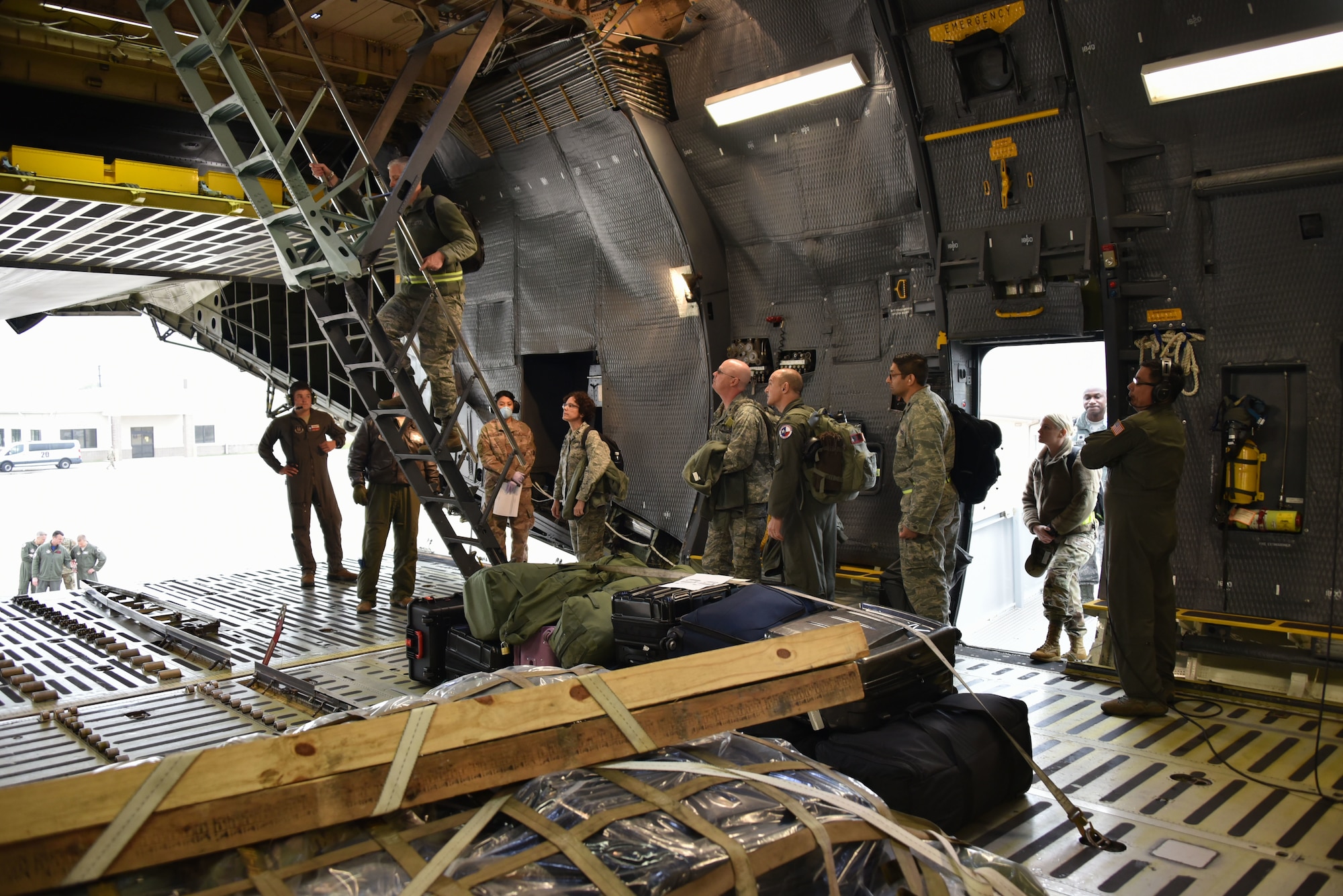 Deploying Airmen from the 301st Fighter Wing Medical Squadron board a C-5M Super Galaxy at U.S. Naval Air Station Joint Reserve Base, Fort Worth, Texas on April 5, 2020. This deployment is part of a larger mobilization package of more than 120 doctors, nurses, and respiratory technicians Air Force Reserve units across the nation provided over the past 48 hours of COVID-19 response to take care of Americans. (U.S. Air Force photos by Capt. Jessica Gross and Tech. Sgt. Melissa Harvey)