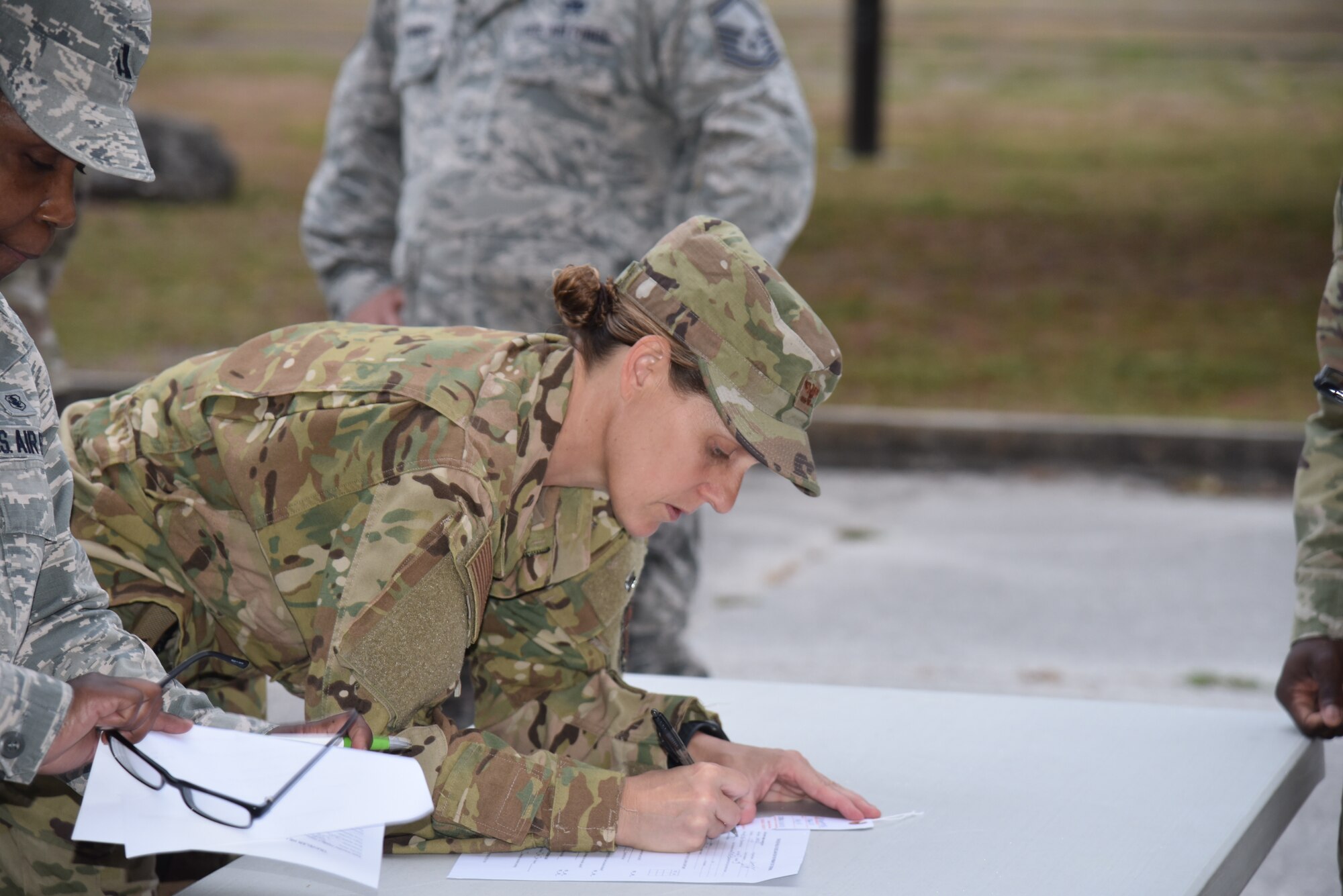 Colonel Jennifer Ratcliff, 927 Aerospace Medicine Squadron Commander, fills out final paperwork in preparation to care for Americans. With less than  24 hours’ notice, doctors and nurses assigned to the 927th Air Refueling Wing boarded a C-130 at MacDill AFB, Fla., April 5, headed for Joint Base McGuire-Lakehurst, N.J. where they will be a part of more than 100 medical professionals sent from Air Force Reserve Command to work with state and local authorities in the region as they combat COVID-19. (U.S. Air Force photo by Tech. Sgt. Peter Dean)