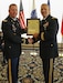 Brig. Gen. Anthony Potts, Program Executive Officer (PEO) Soldier, presents Col. Douglas W. Copeland, Project Manager Soldier Sensors and Lasers (PM SSL) at Program Executive Office Soldier, the PM SSL Charter, at Fort Belvoir, Va., July 26, 2019.  Copeland relieved Col. Christopher D. Schneider during the PM SSL change of charter.
