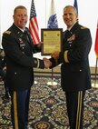 Brig. Gen. Anthony Potts, Program Executive Officer (PEO) Soldier, presents Col. Douglas W. Copeland, Project Manager Soldier Sensors and Lasers (PM SSL) at Program Executive Office Soldier, the PM SSL Charter, at Fort Belvoir, Va., July 26, 2019.  Copeland relieved Col. Christopher D. Schneider during the PM SSL change of charter.