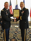 Brig. Gen. Anthony Potts, Program Executive Officer (PEO) Soldier, presents Col. Douglas W. Copeland, Project Manager Soldier Sensors and Lasers (PM SSL) at Program Executive Office Soldier, the PM SSL Charter, at Fort Belvoir, Va., July 26, 2019.  Copeland relieved Col. Christopher D. Schneider during the PM SSL change of charter.