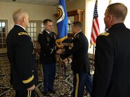 Master Sgt. Marc Krugh, Senior Enlisted Advisor, Project Manager Integrated Visual Augmentation System at Program Executive Office Soldier, presents Col. Christopher D. Schneider, Project Manager Soldier Sensors and Lasers (PM SSL), the U.S. Army Acquisition Corps colors during the PM SSL change of charter, at Fort Belvoir, Va., July 26, 2019. Schneider was relieved by Col. Douglas W. Copeland and will be continuing on as Program Manager Integrated Visual Augmentation System at PEO Soldier.