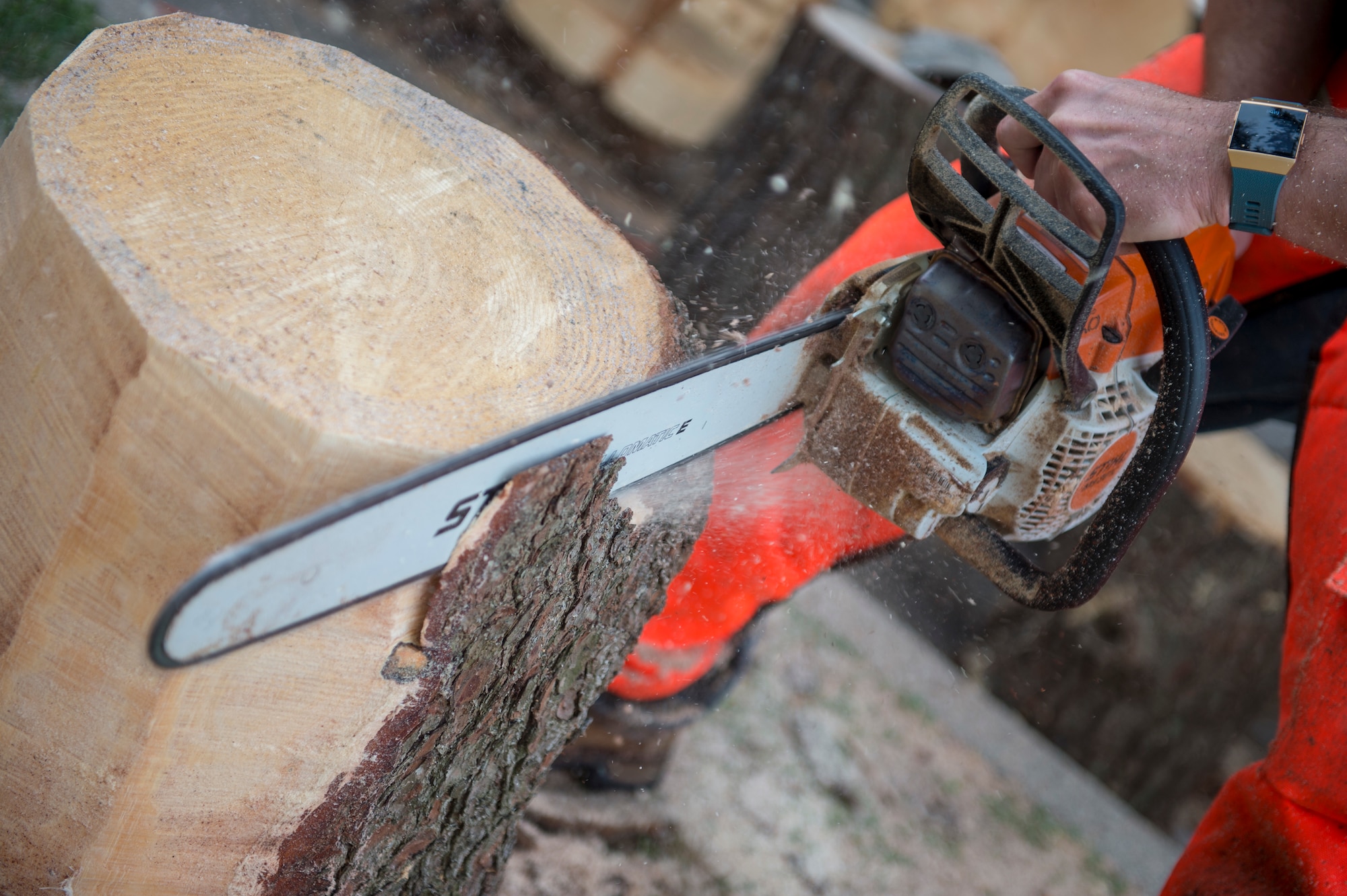 U.S. Air Force Tech. Sgt. Scott Herbert, 818th Mobility Support Advisory Squadron air advisor, cuts off bark from a log to prepare it for carving an art piece March 12, 2020, at his house on Joint Base McGuire-Dix-Lakehurst, New Jersey. Herbert has three chainsaws to work different cuts and details into his art. (U.S. Air Force photo by Staff Sgt. Sarah Brice)
