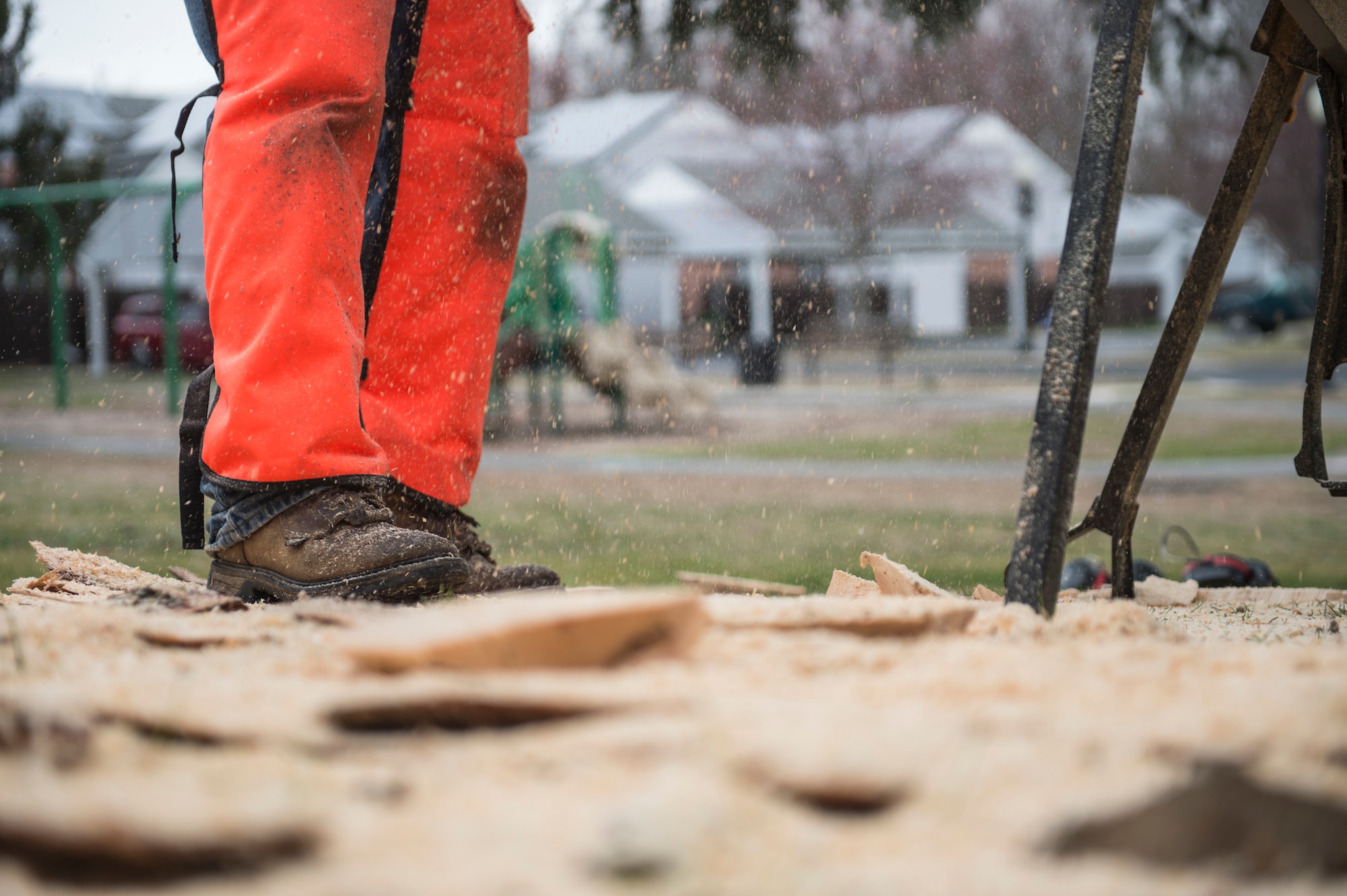 Sawdust begins to build up around U.S. Air Force Tech. Sgt. Scott Herbert, 818th Mobility Support Advisory Squadron air advisor, as he cuts more wood off of a developing carving sculpture March 12, 2020, Joint Base McGuire-Dix-Lakehurst, New Jersey. Herbert has three chainsaws to work different cuts and details into his art. (U.S. Air Force photo by Staff Sgt. Sarah Brice)