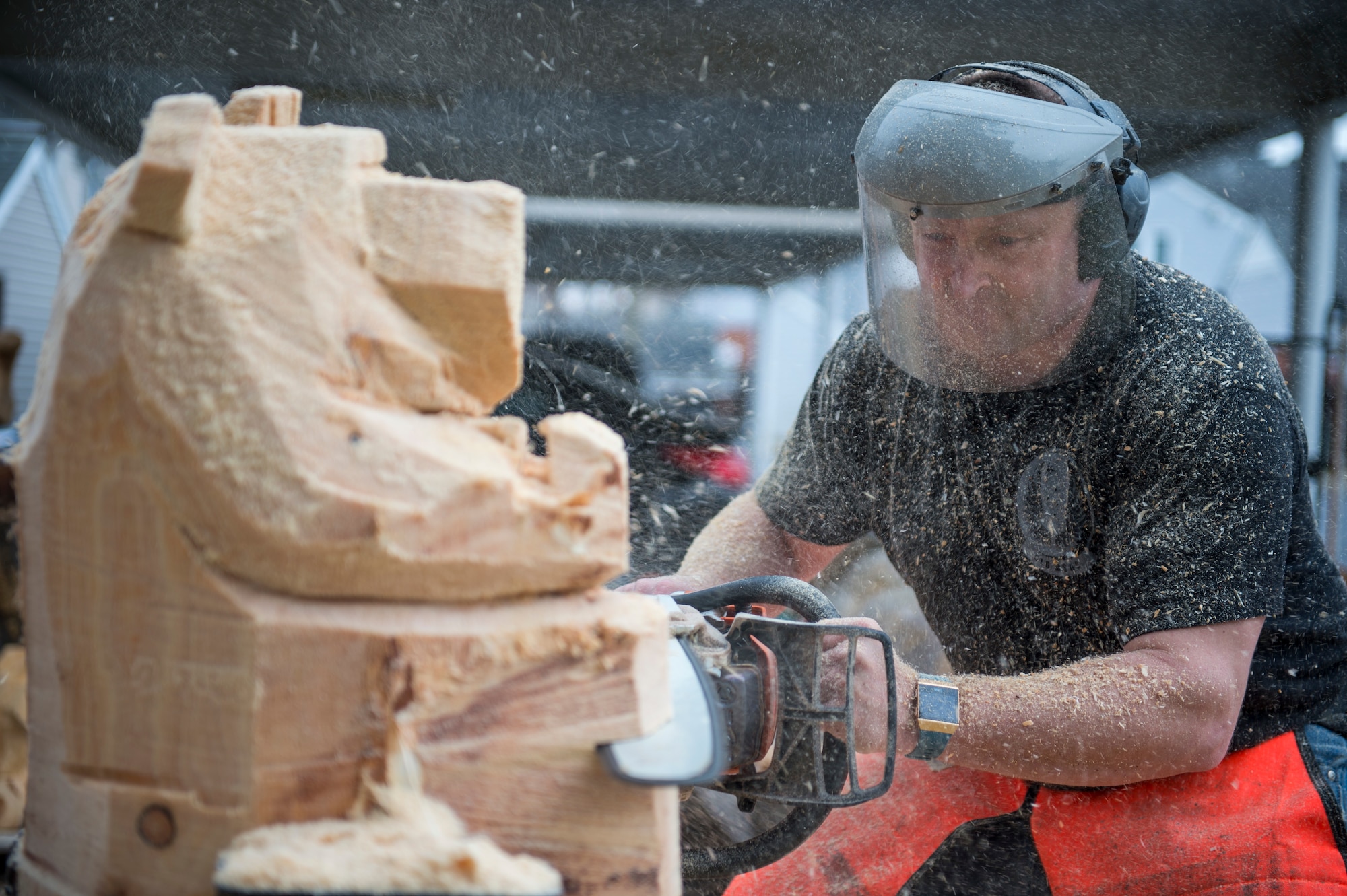 U.S. Air Force Tech. Sgt. Scott Herbert, 818th Mobility Support Advisory Squadron air advisor, uses a chainsaw to cut a rough figure of a bear statue March 12, 2020, Joint Base McGuire-Dix-Lakehurst, New Jersey. Herbert has been practicing chainsaw art for two years and has carved owls, eagles, rams, snails, trees, pumpkins, fish and bears. (U.S. Air Force photo by Staff Sgt. Sarah Brice)