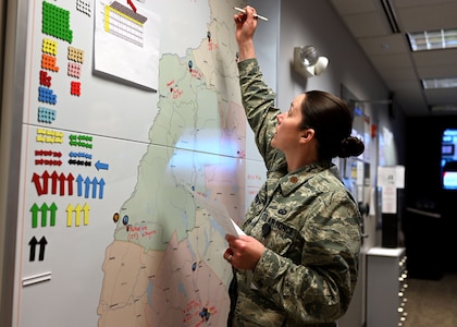 Maj. Moira Cuthbert, chief of operations, New Hampshire National Guard, tracks COVID-19 missions at the Joint Operations Center.