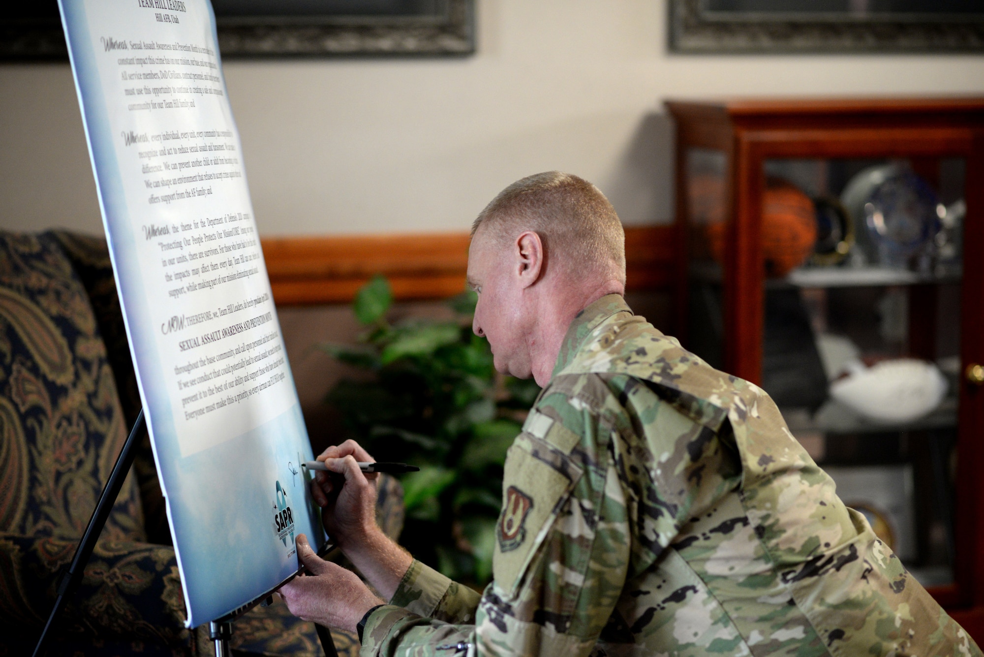 Col. Jon Eberlan, 75th Air Base Wing commander, signs the Sexual Assault Awareness and Prevention Month (SAAPM) proclamation.