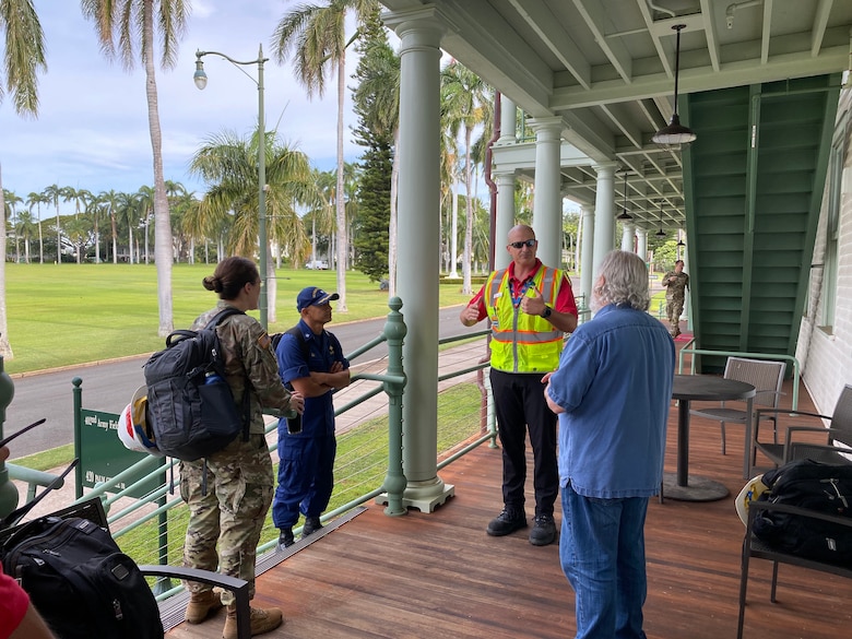 U S. Army Corps of Engineers Honolulu District Commander Lt. Col. Kathryn Sanborn (left) and members of the USACE site assessment team listen to team leader Jeff Herzog explain aspects of the team's mission prior to boarding a military helicopter flight to Kauai.